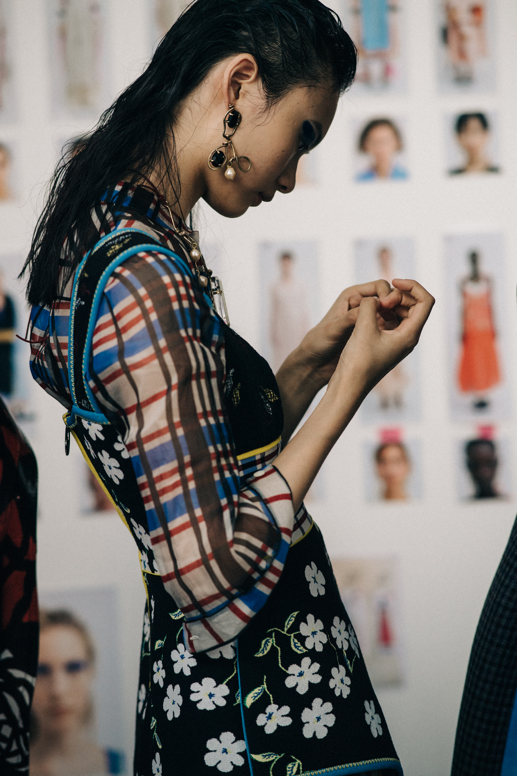 Model backstage in check outfit