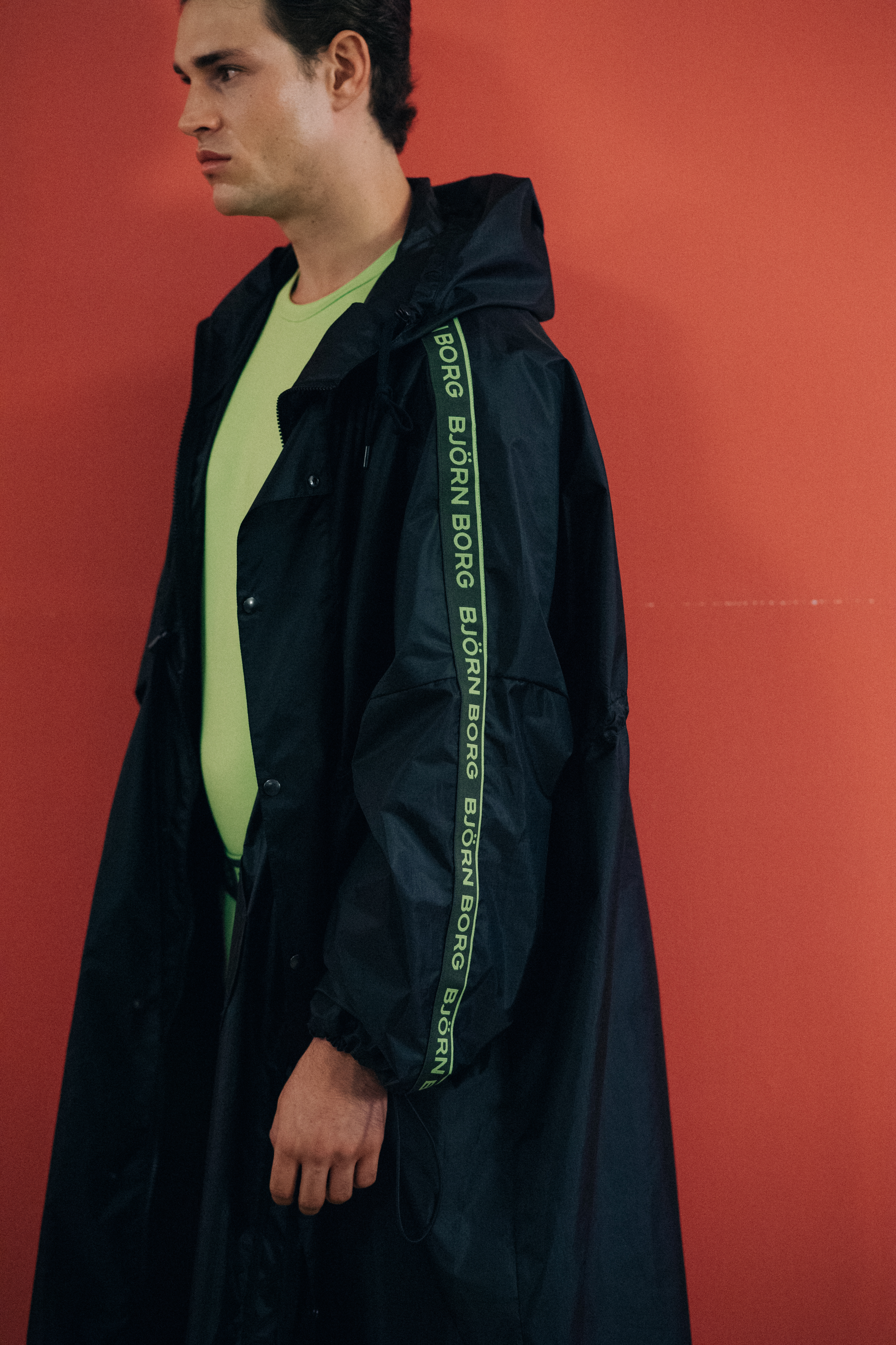 Male model wearing sporty rain jacket