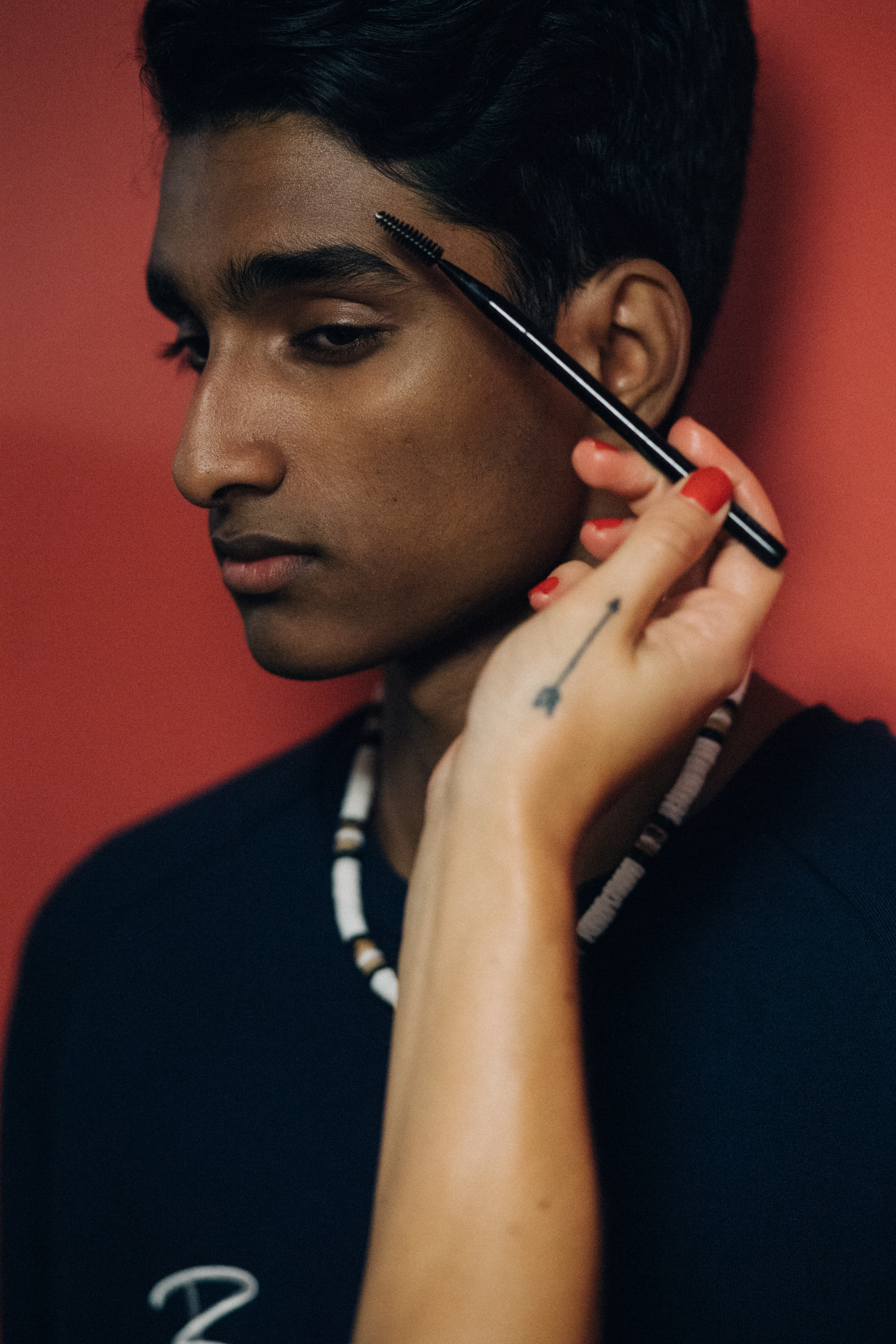 Male model getting make up done