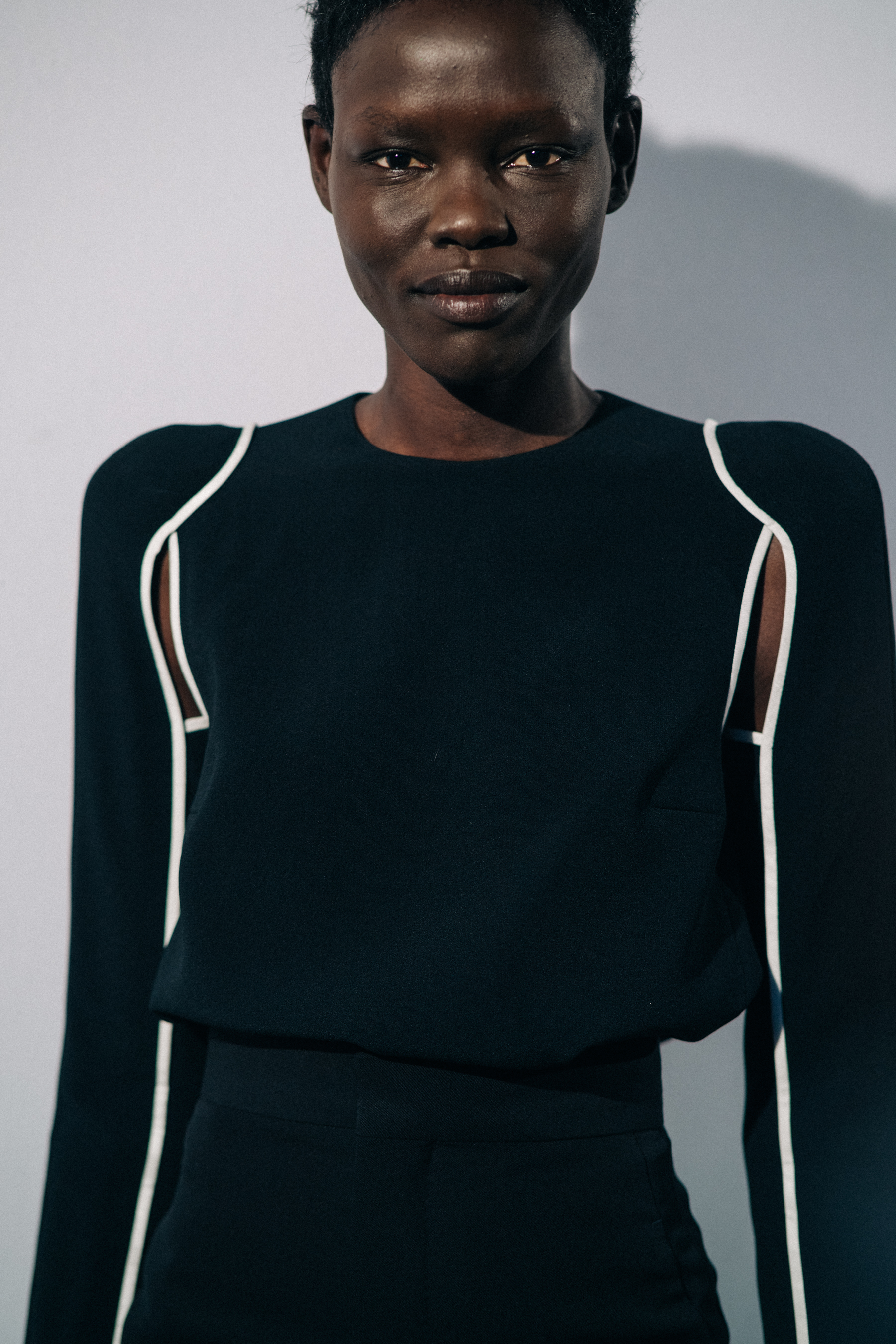 Model wearing black before a show