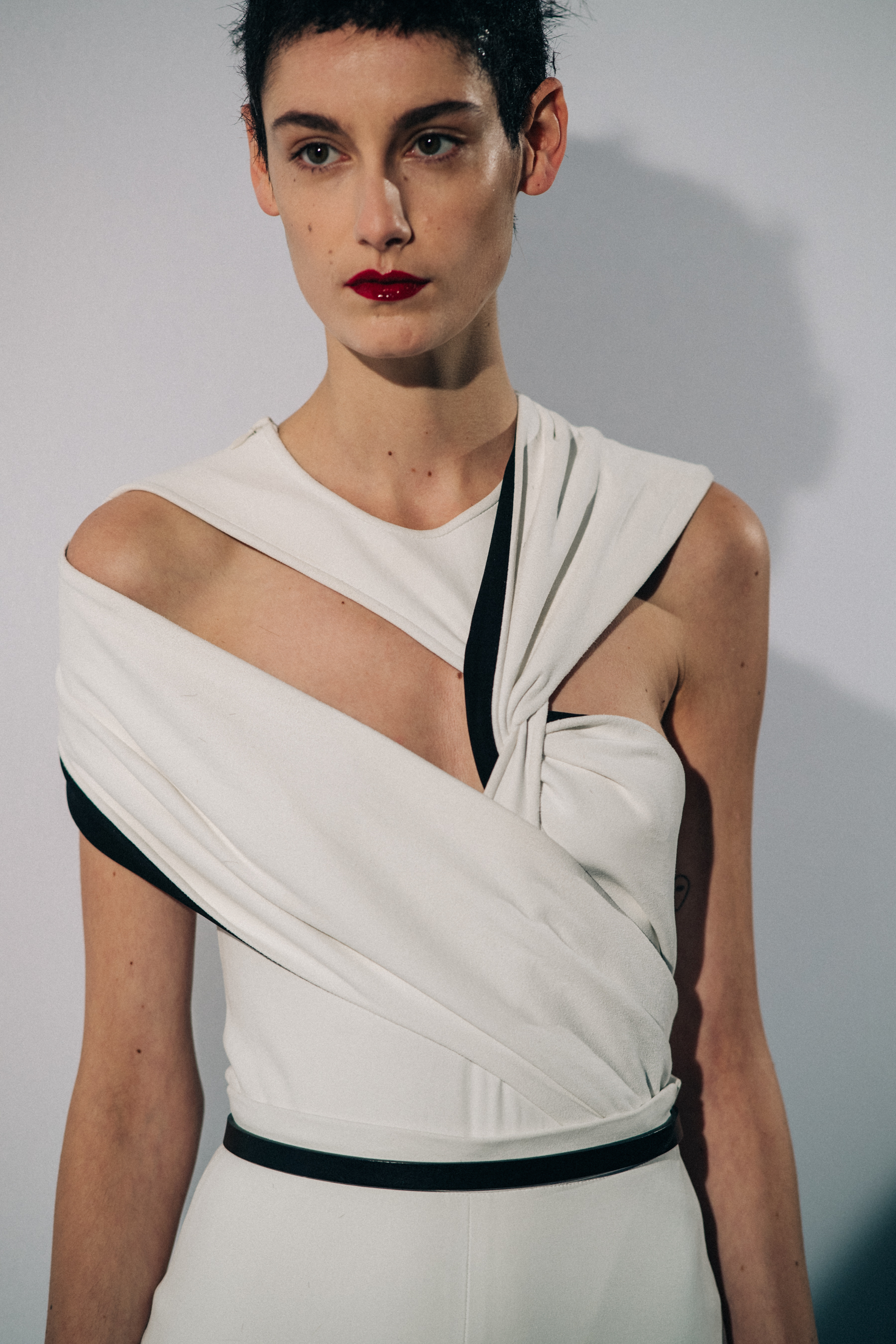 Model wearing white before a show