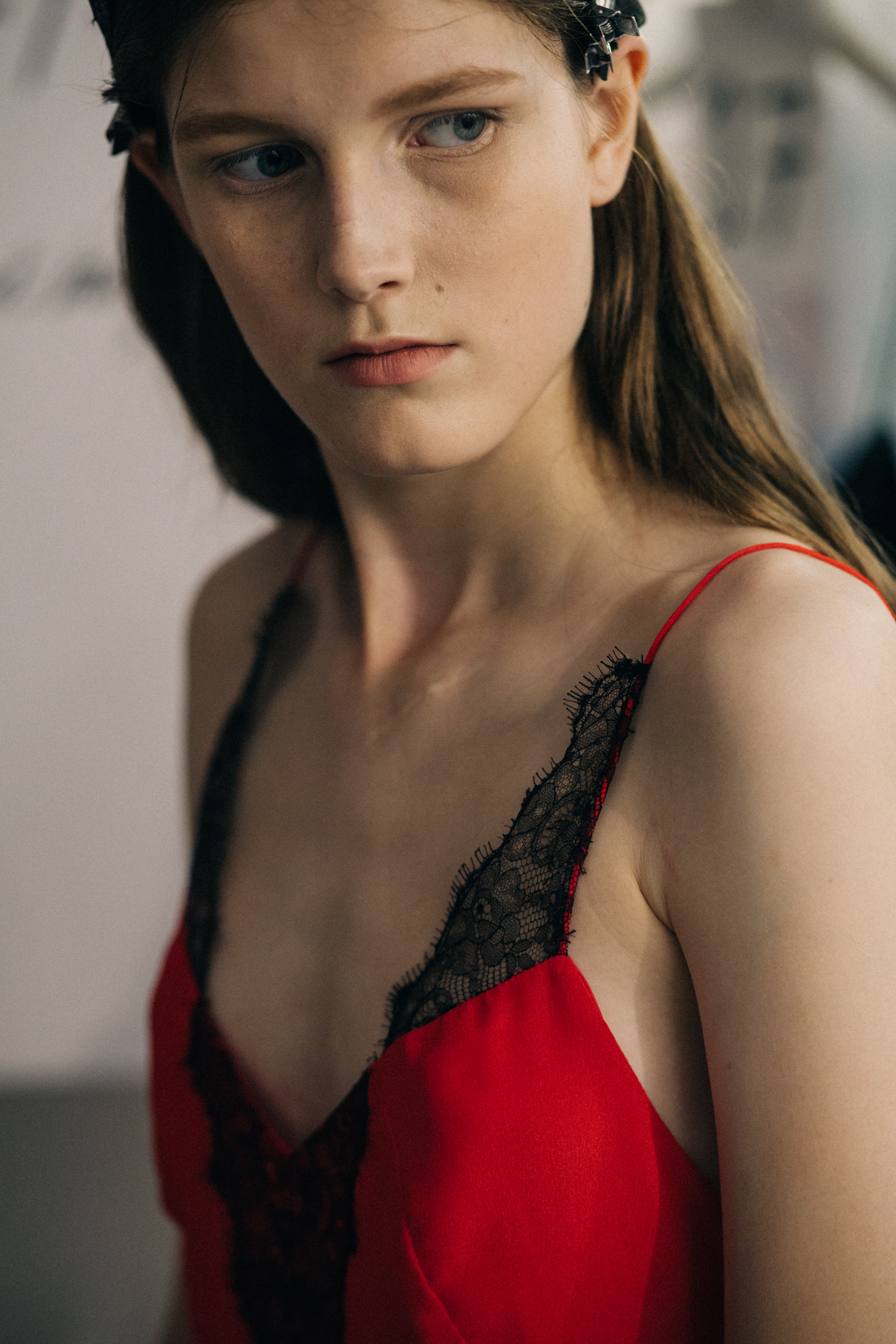 Model wearing red outfit before a show