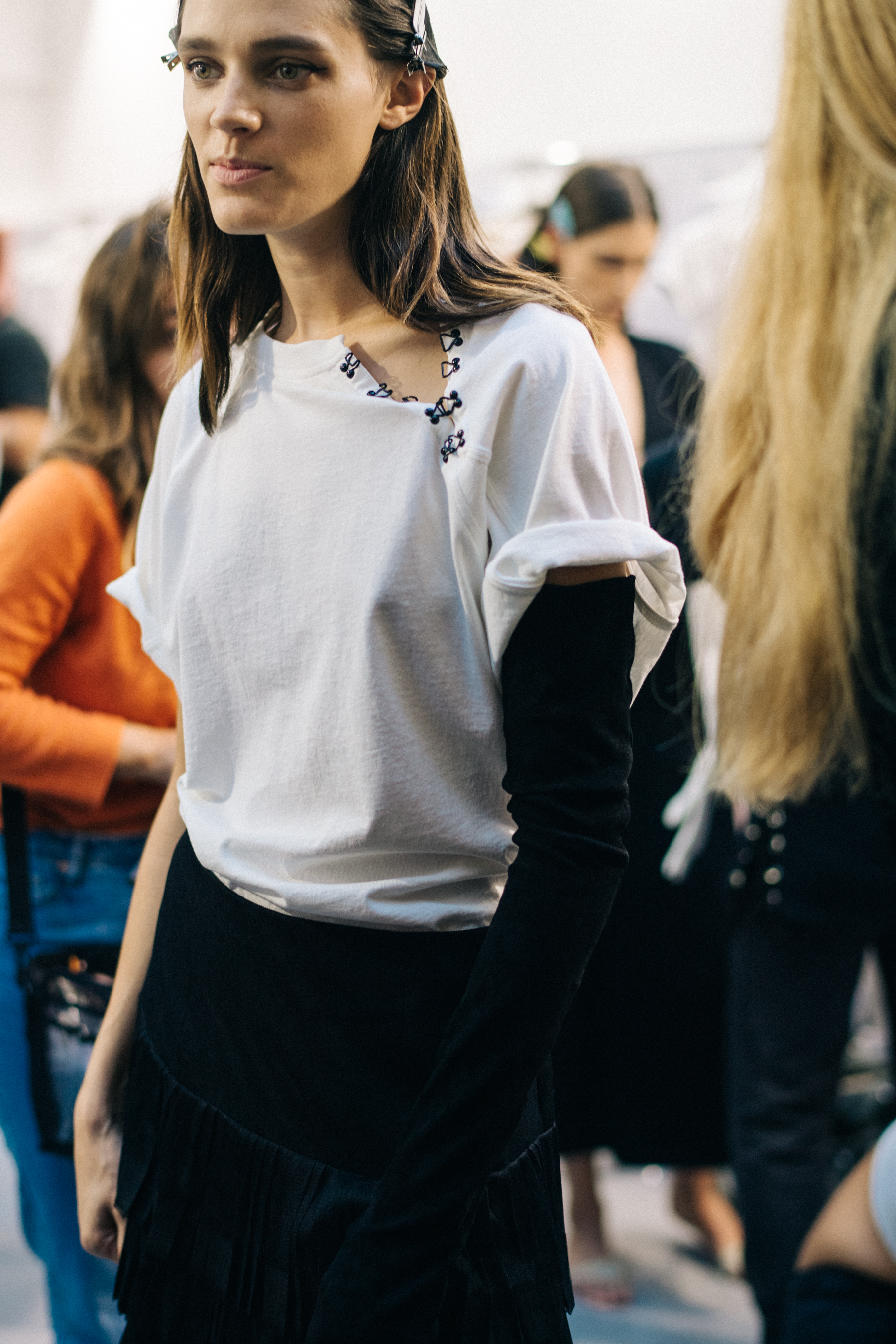 Model wearing white dress before a show