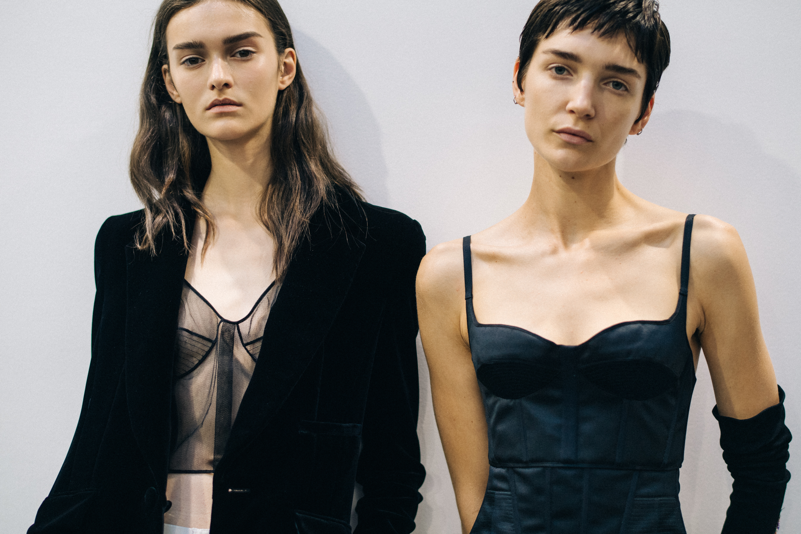 Model wearing black outfit before a show