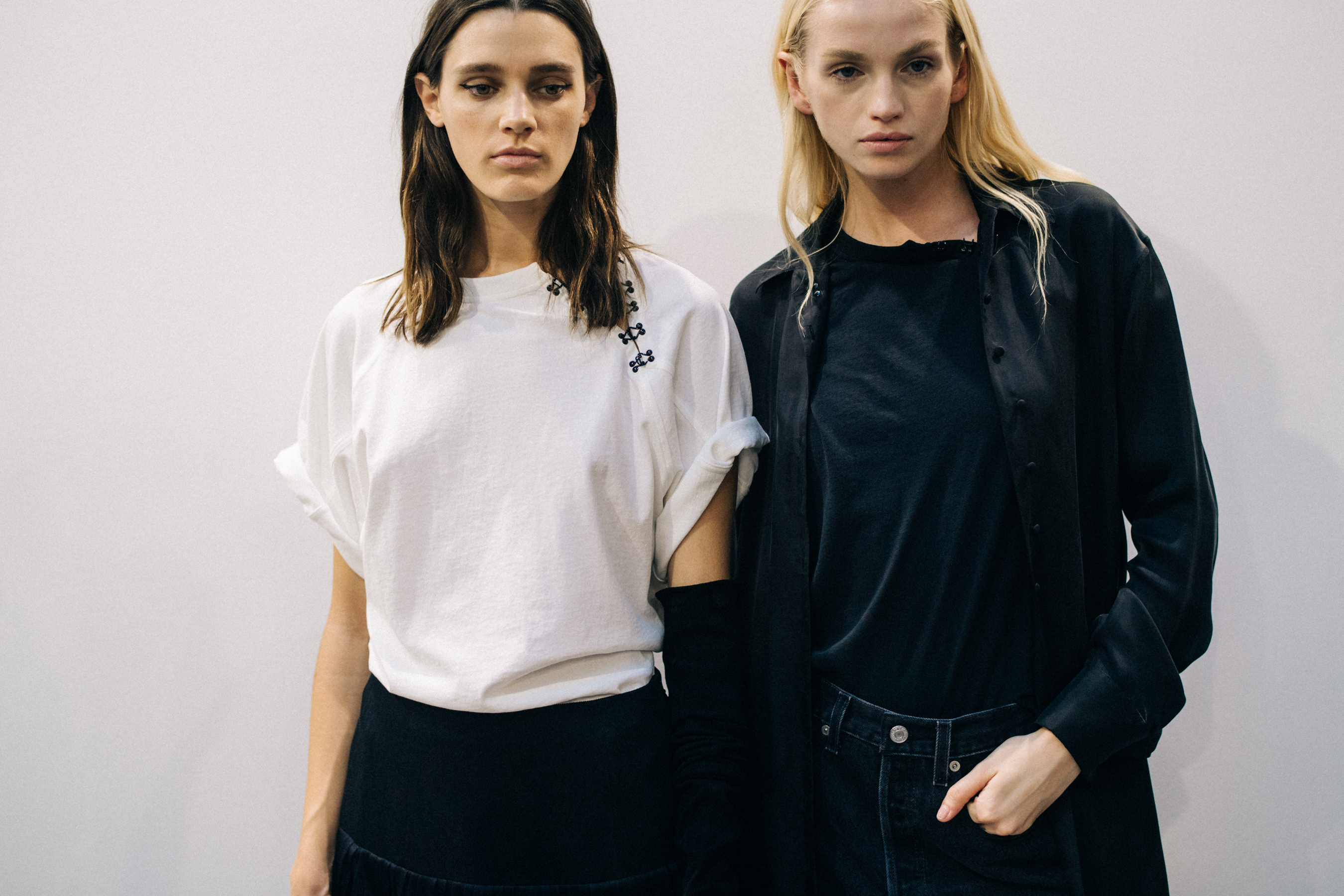 Model wearing black outfit before a show