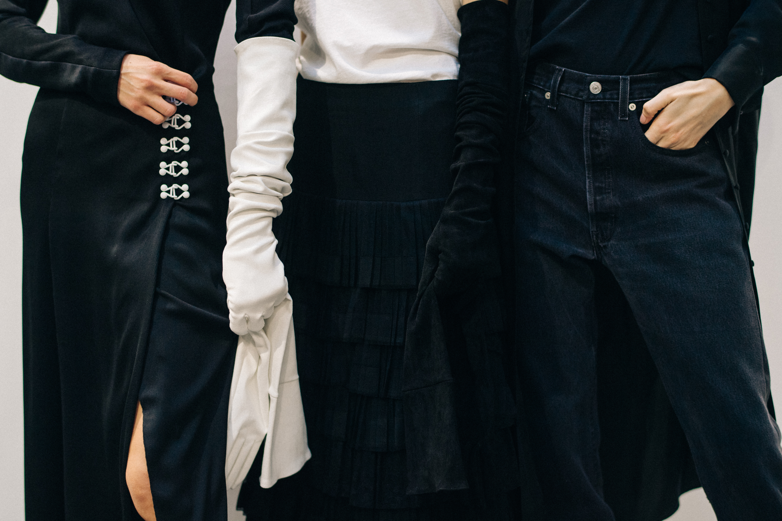 Model wearing black outfit before a show