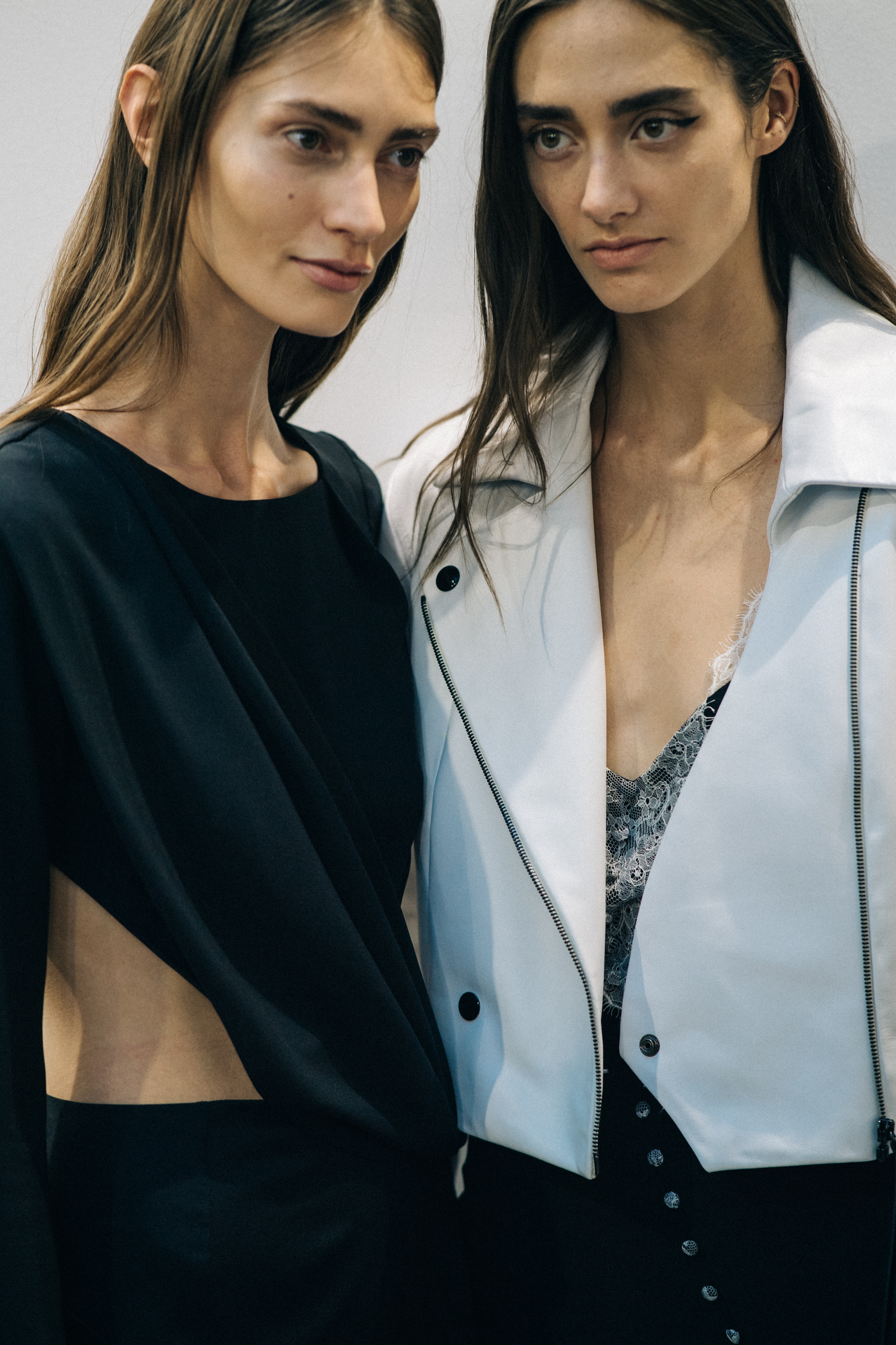 Model wearing black outfit before a show