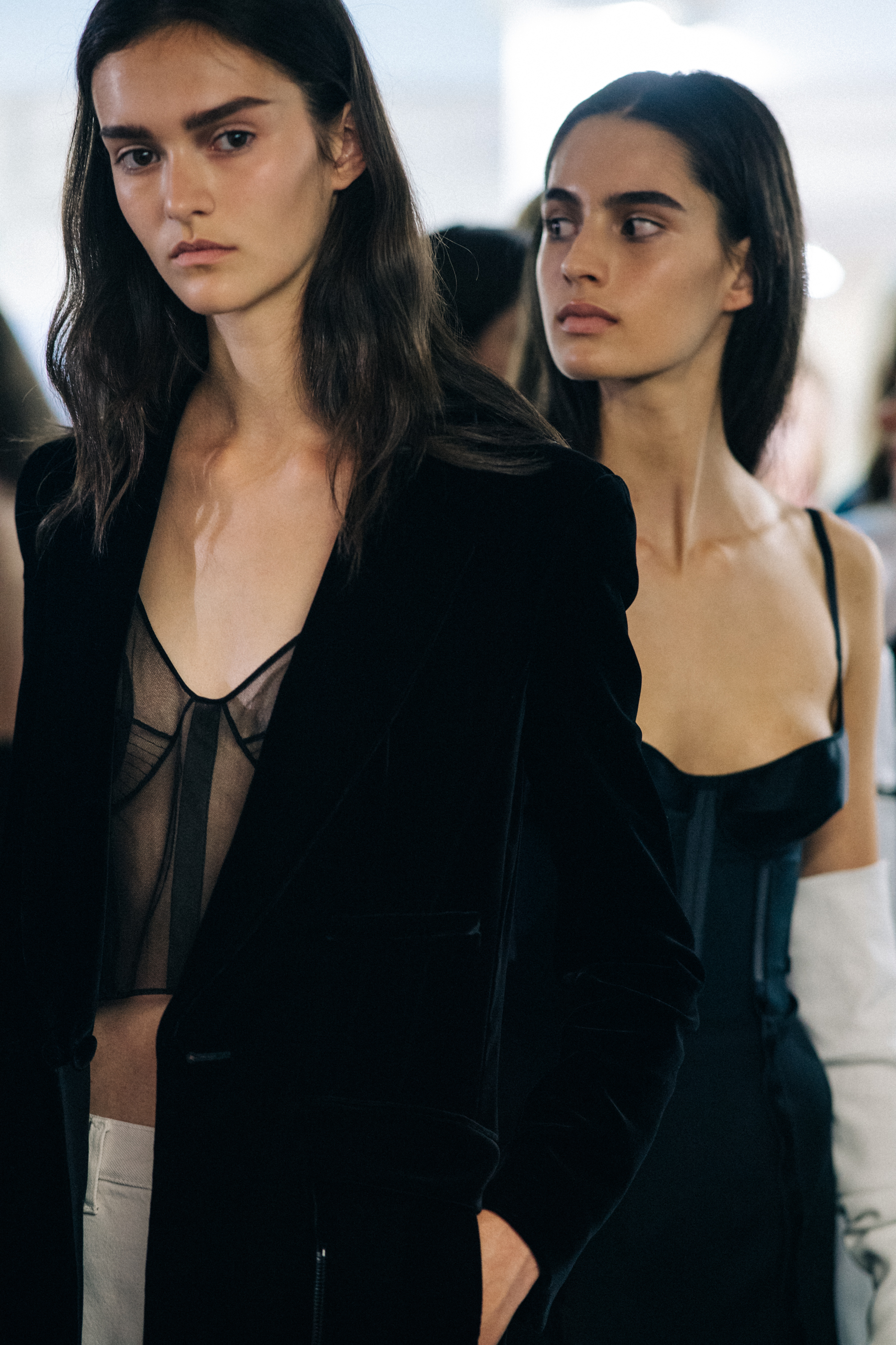 Model wearing black outfit before a show