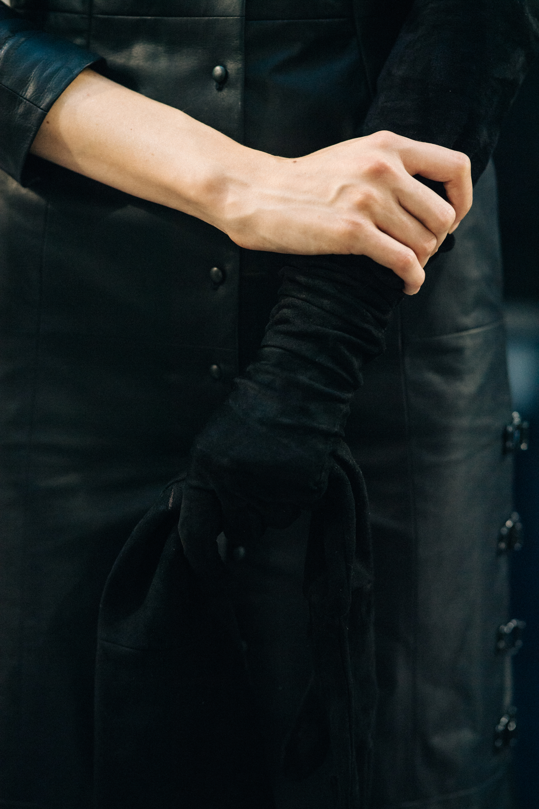 Model wearing black outfit before a show