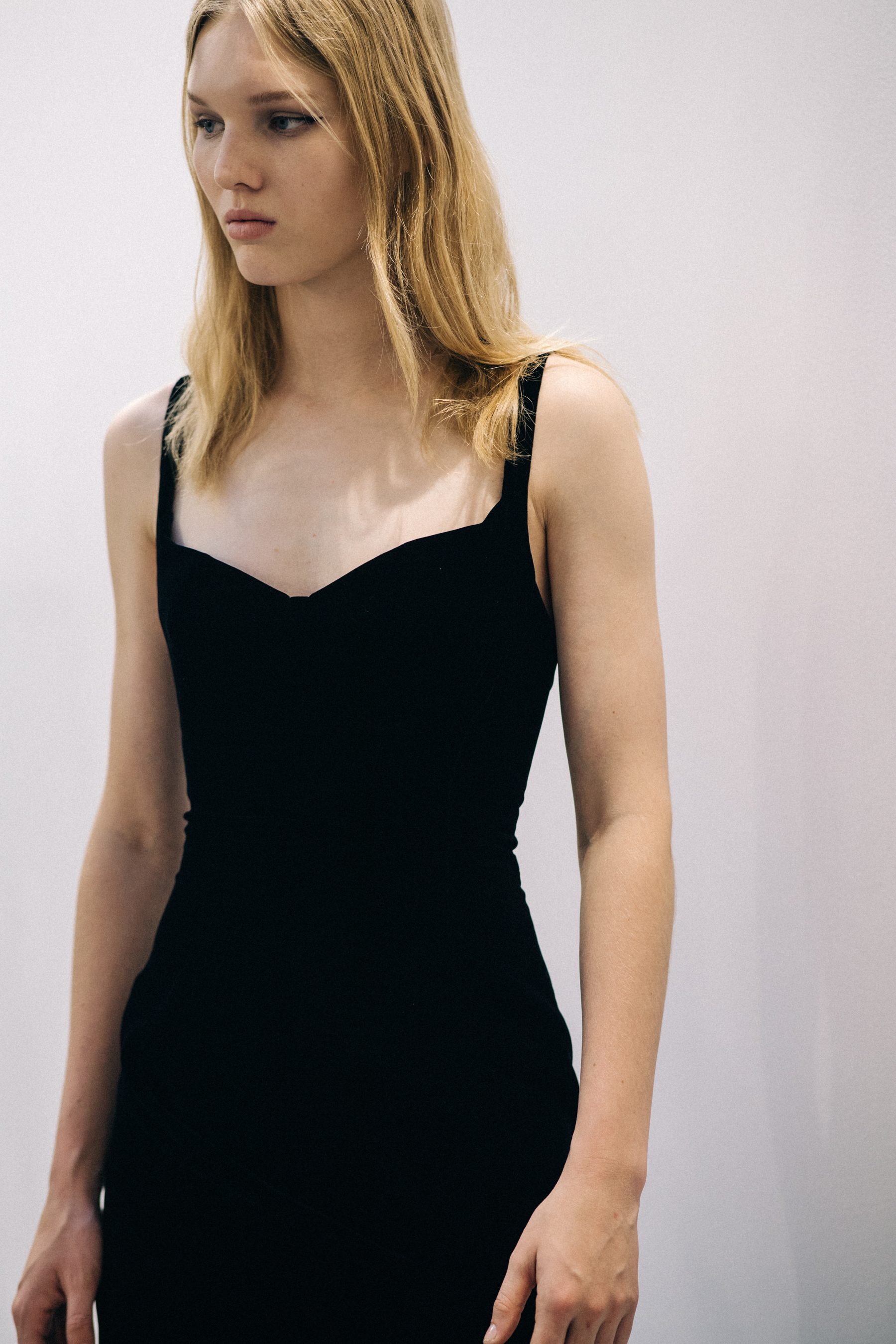 Model wearing black outfit before a show