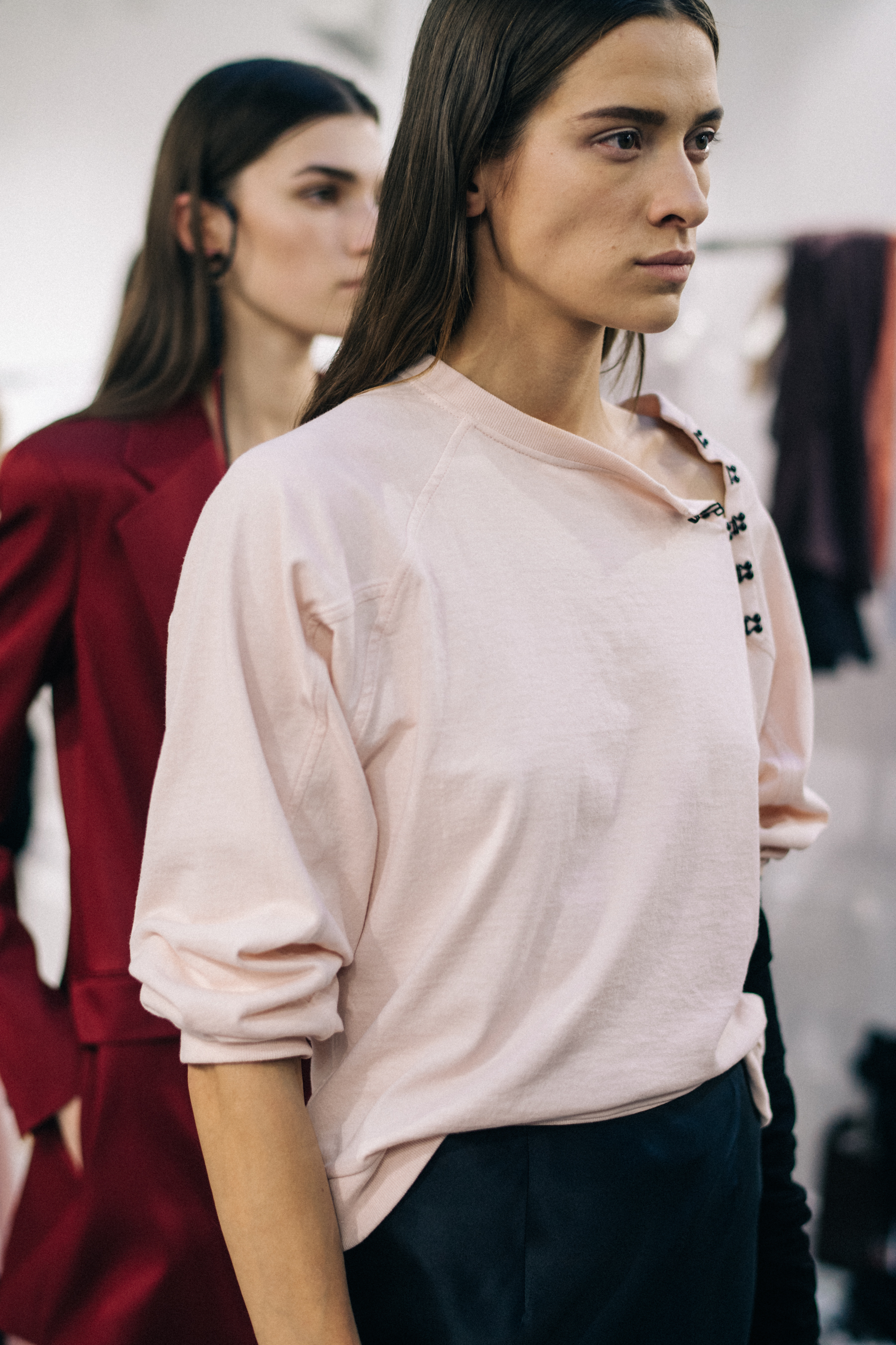 Model wearing white dress before a show