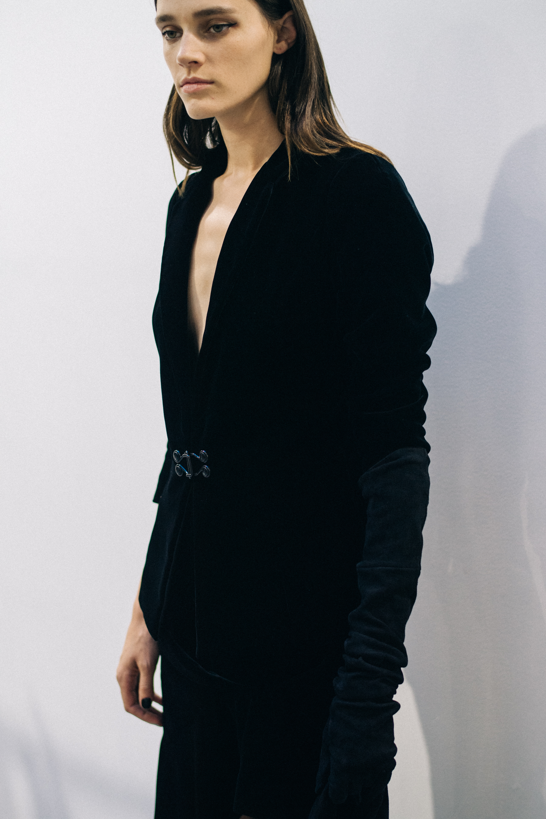 Model wearing black outfit before a show