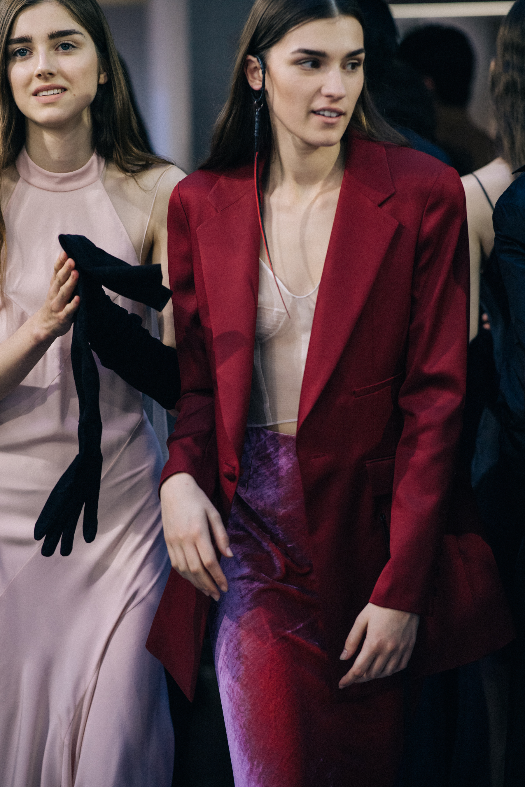 Model wearing red outfit before a show