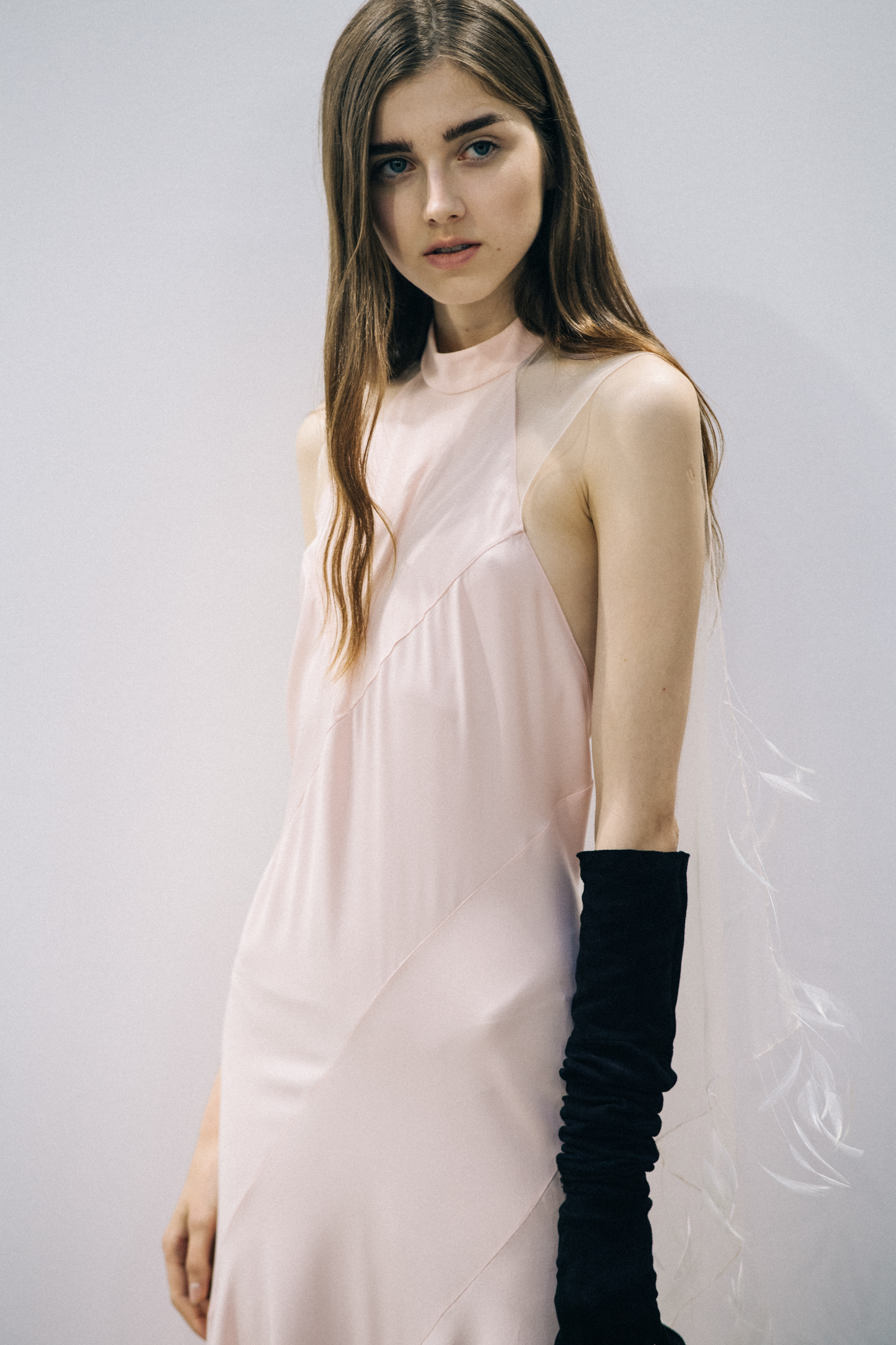 Model wearing white dress before a show