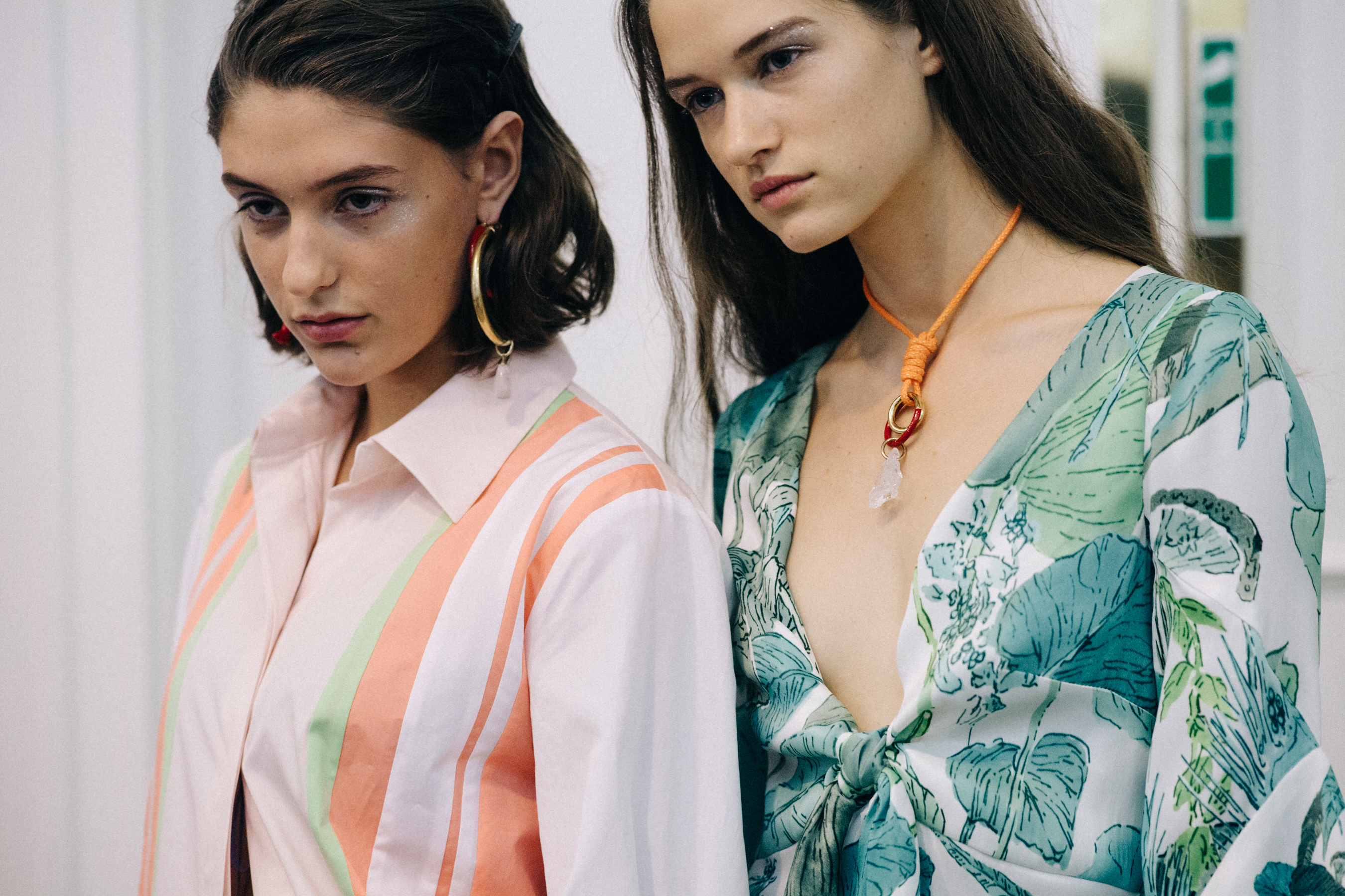 Group of models wearing colourful dresses
