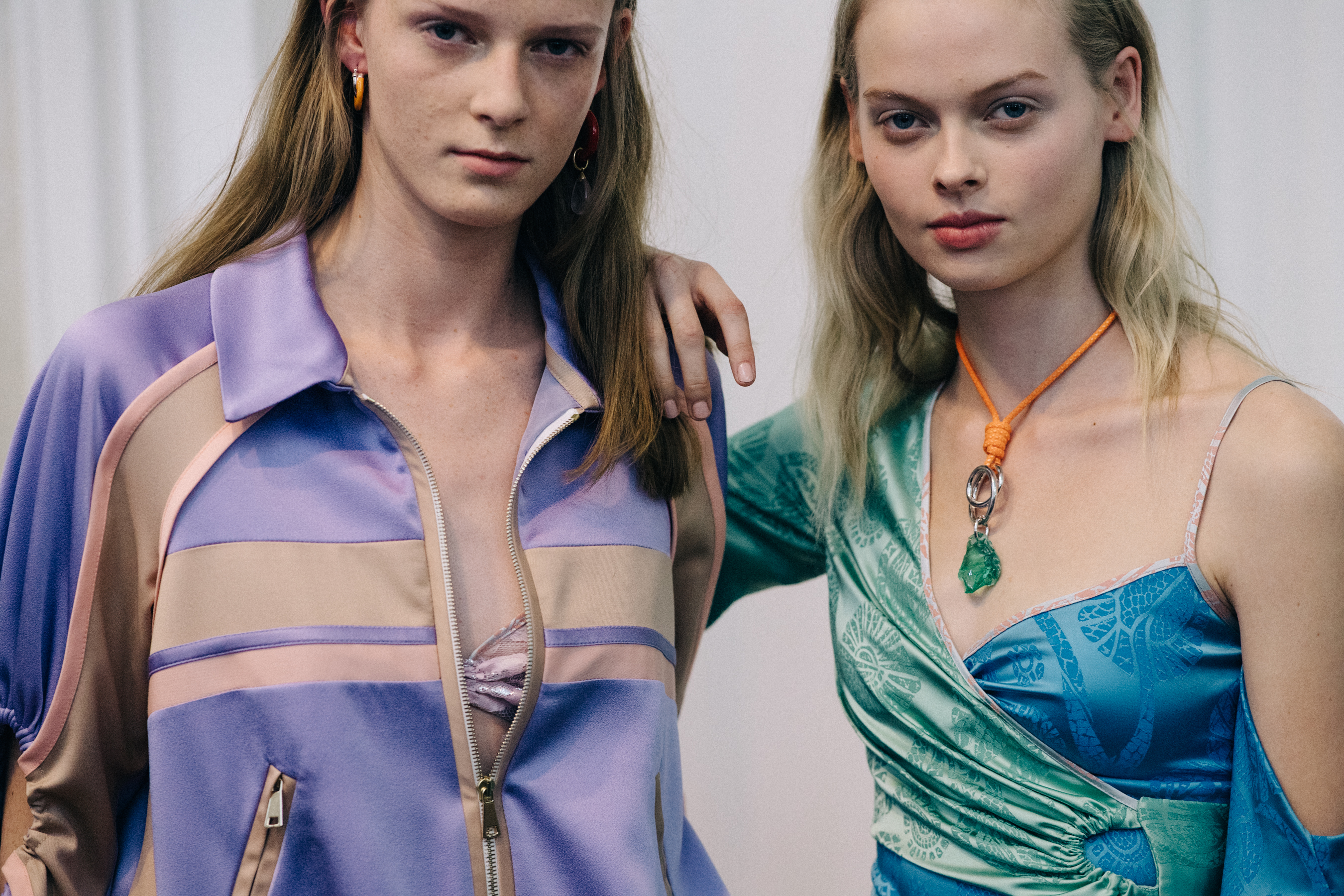 Group of models wearing colourful dresses