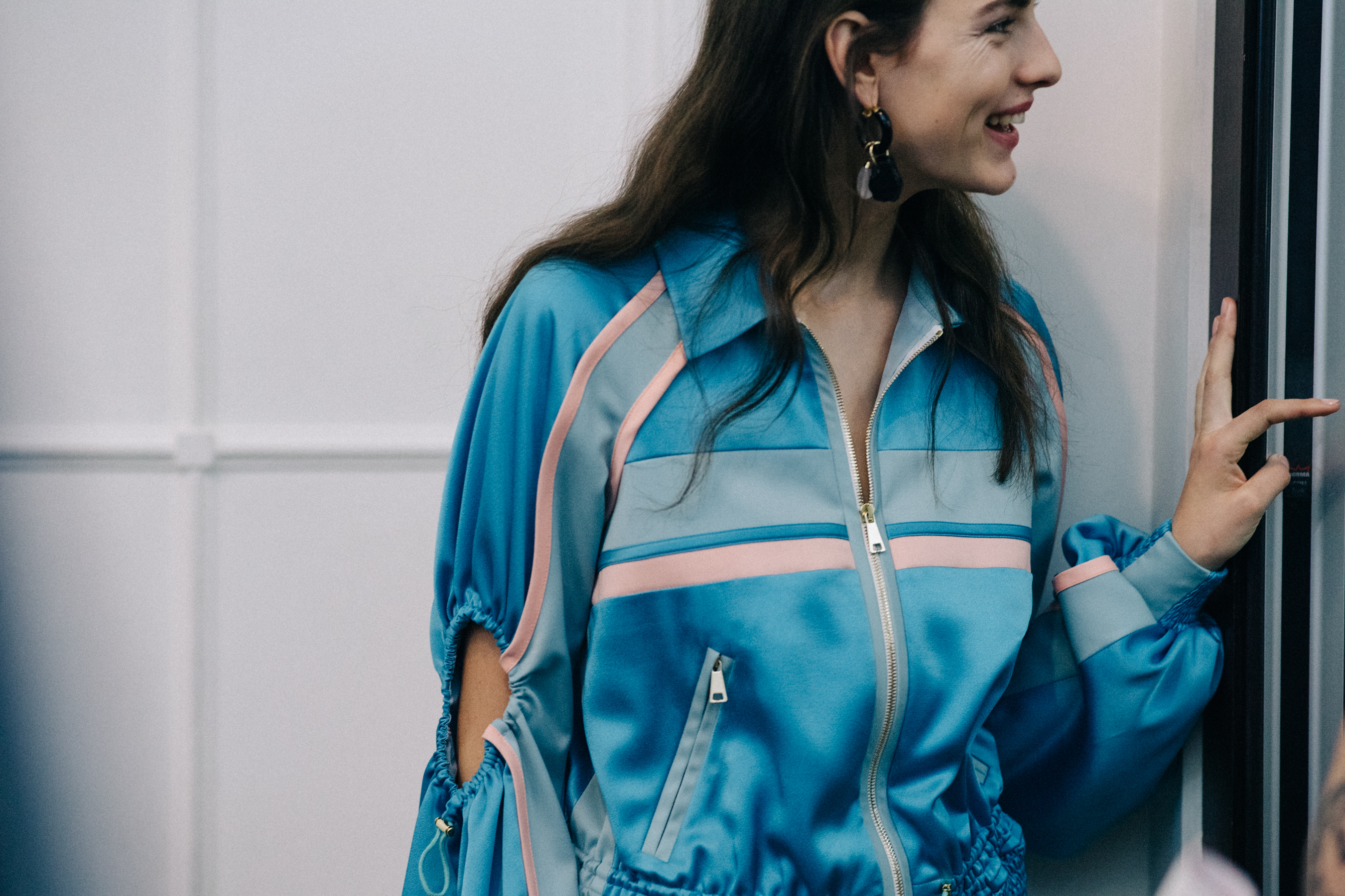 Model wearing blue silk tracksuit