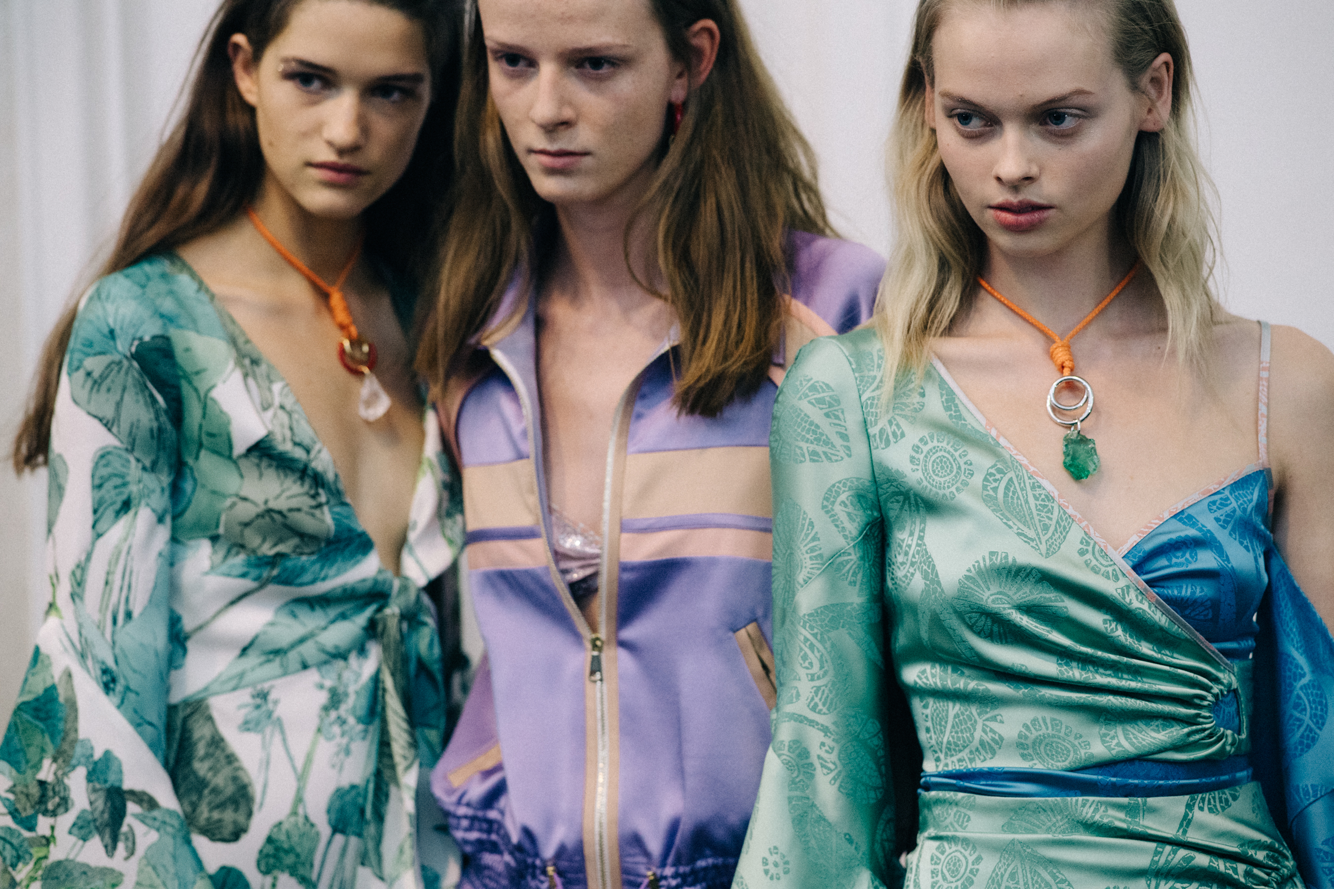 Group of models wearing colourful dresses