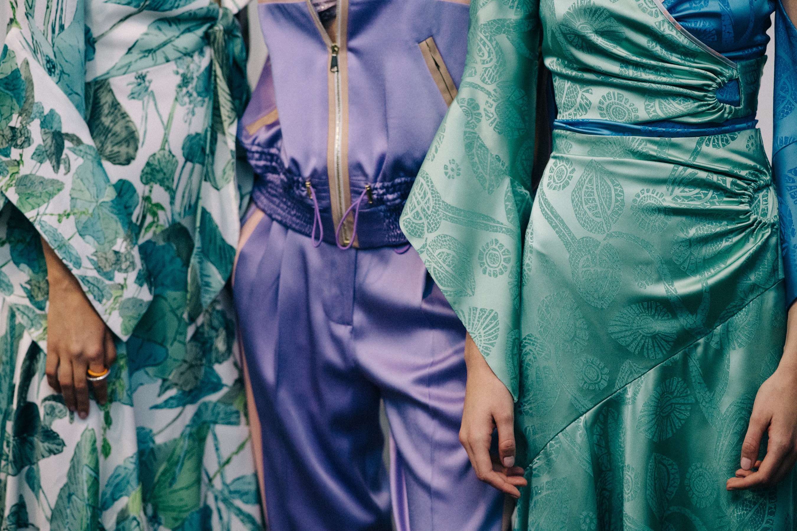 Group of models wearing colourful dresses