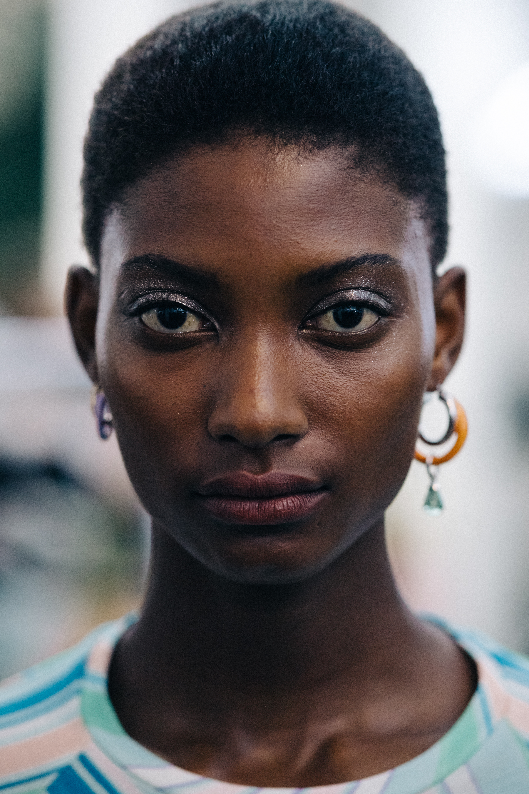 Portrait of a model wearing colourful earrings