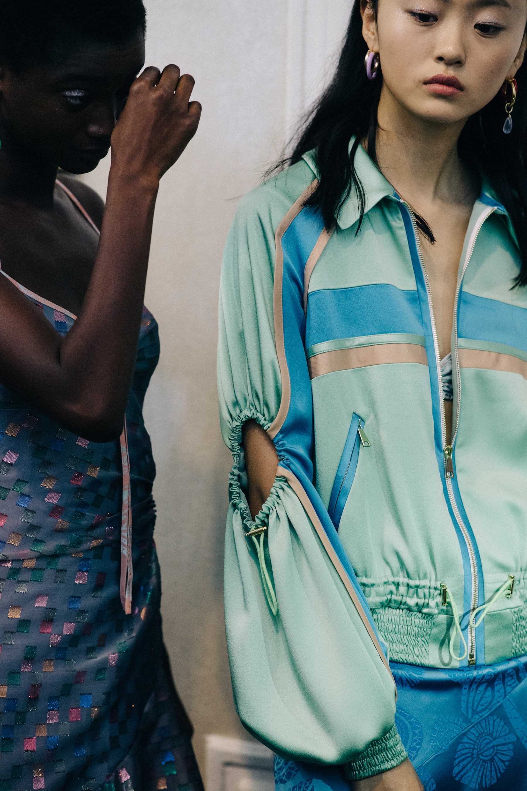 Group of models wearing colourful dresses