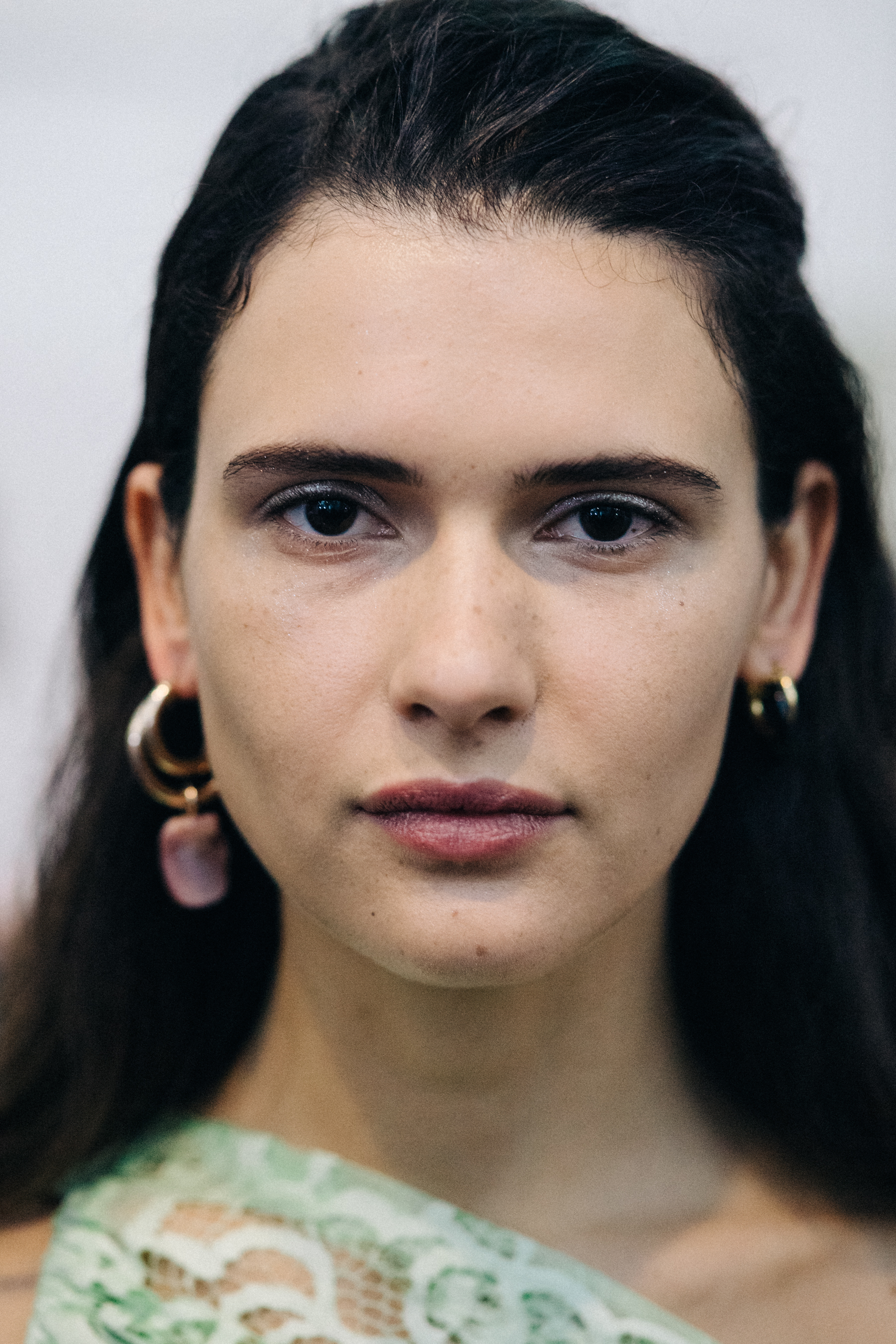 Portrait of a model wearing colourful earrings