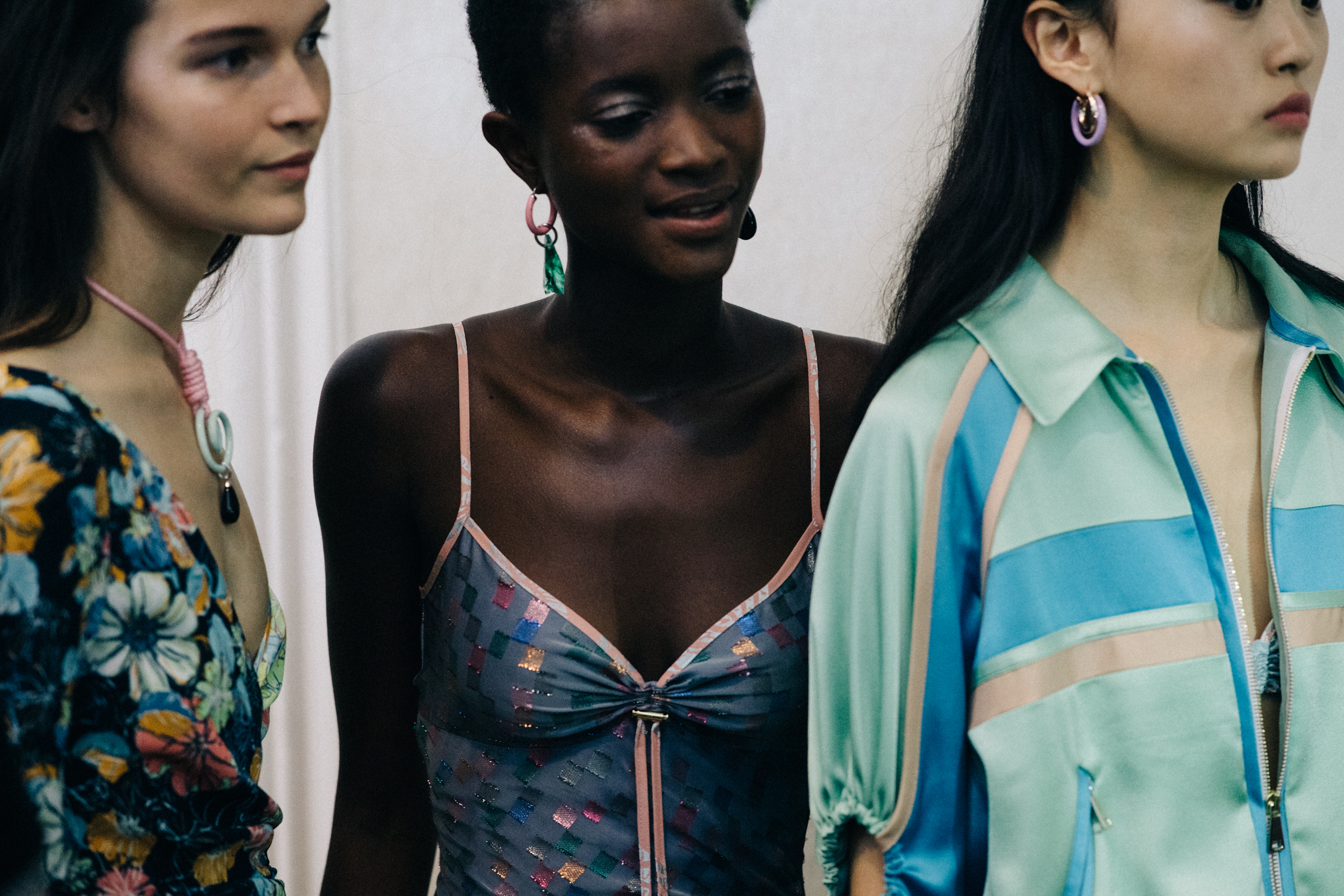 Group of models wearing colourful dresses
