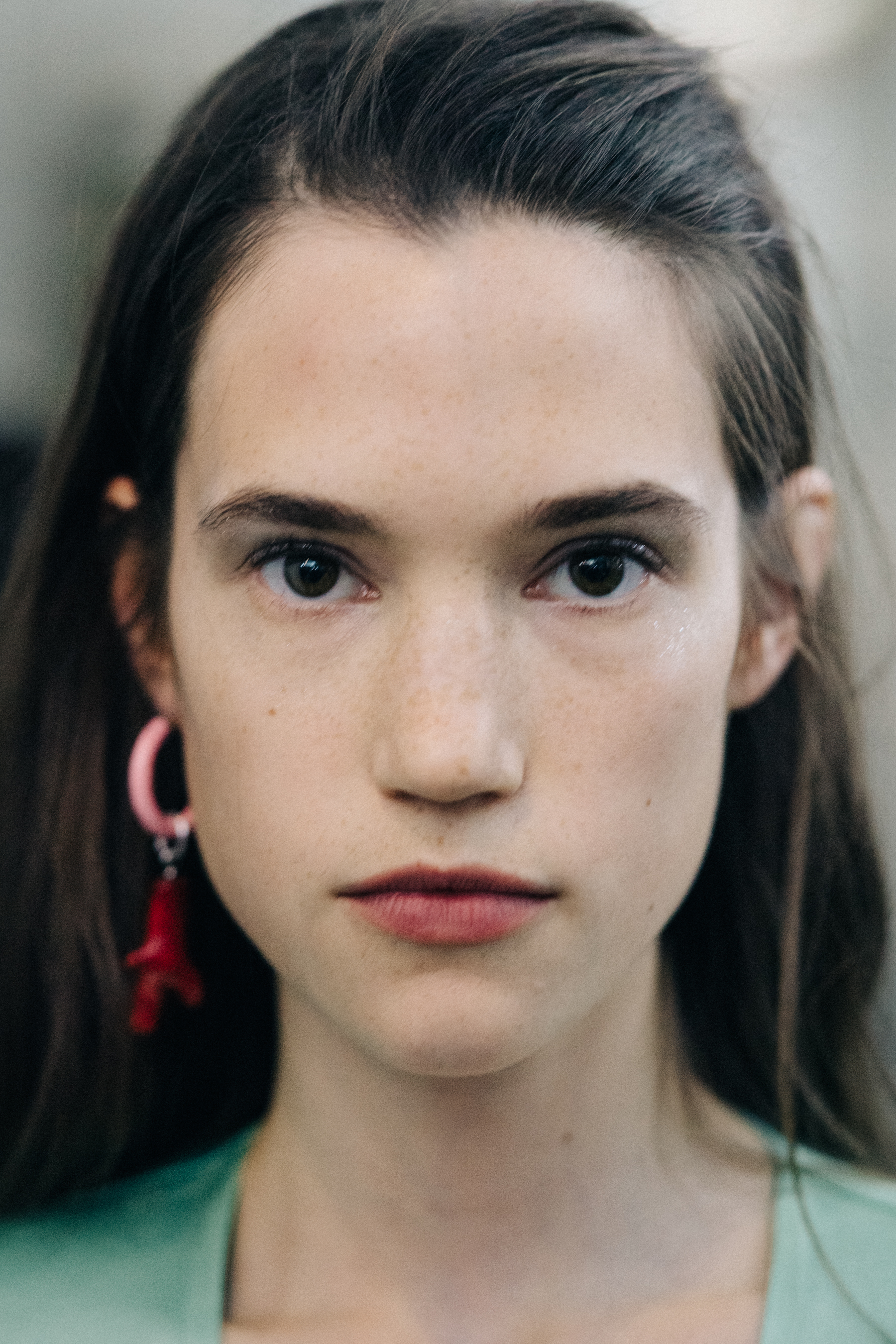 Portrait of a model wearing colourful earrings