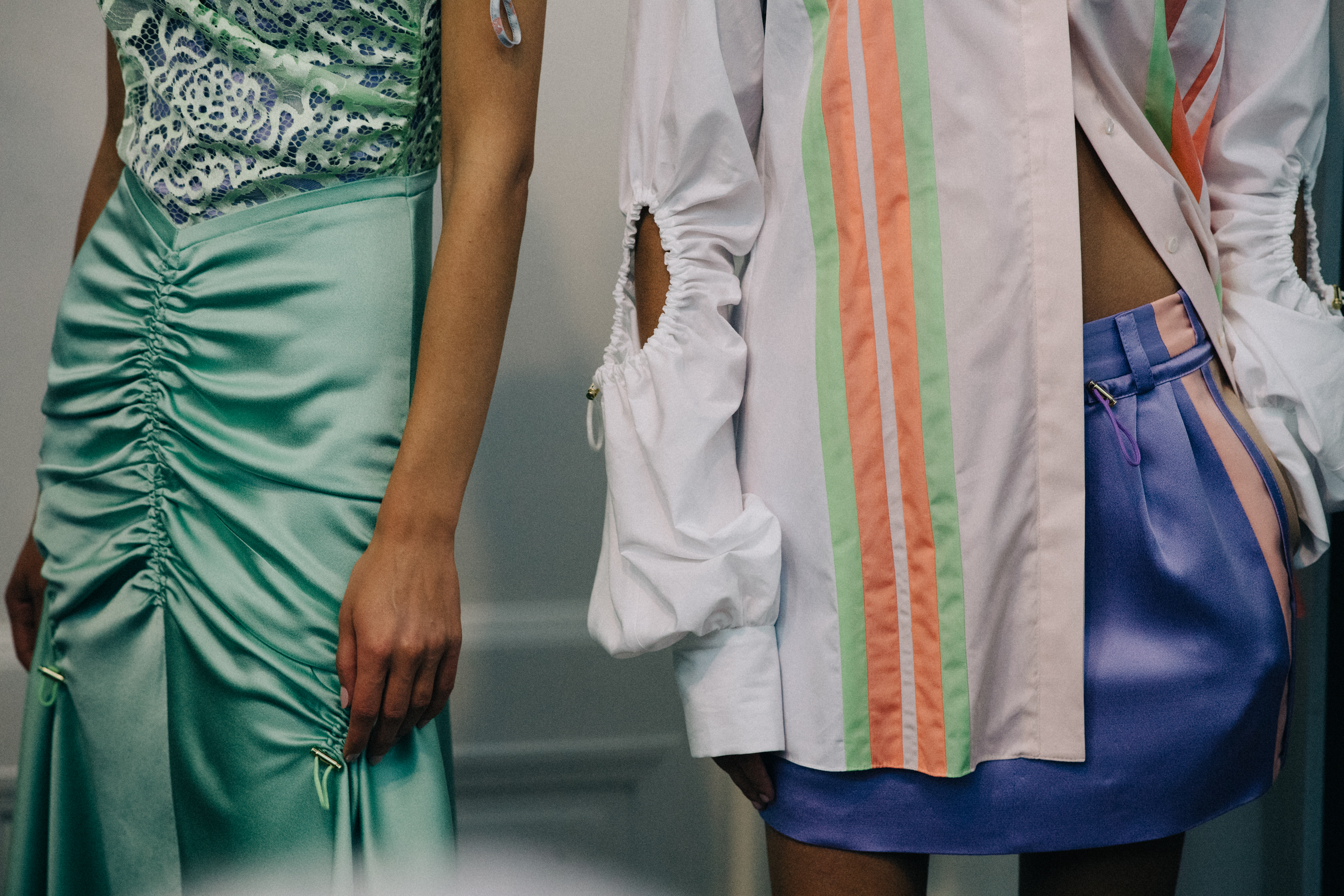 Group of models wearing colourful dresses