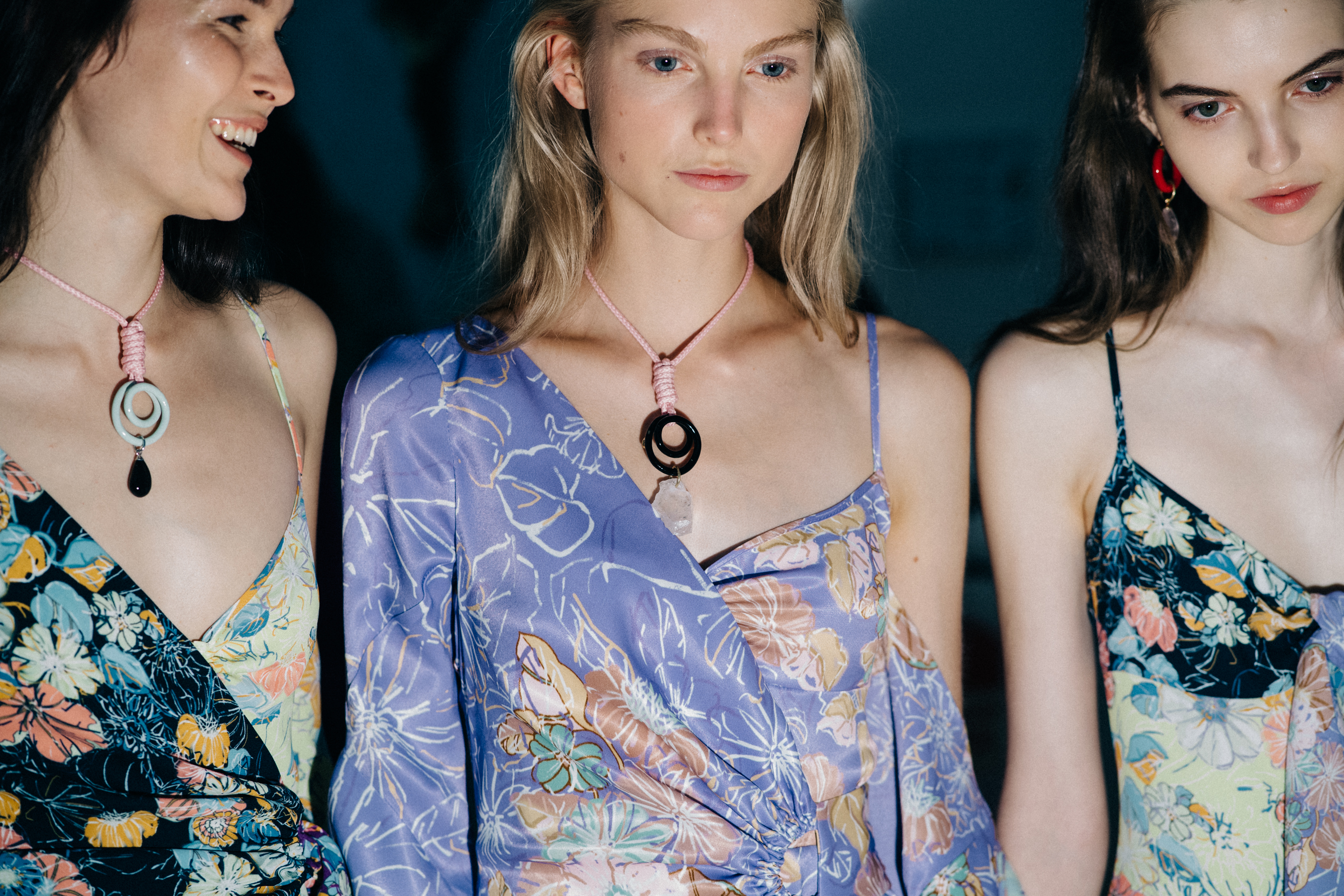 Group of models wearing colourful dresses