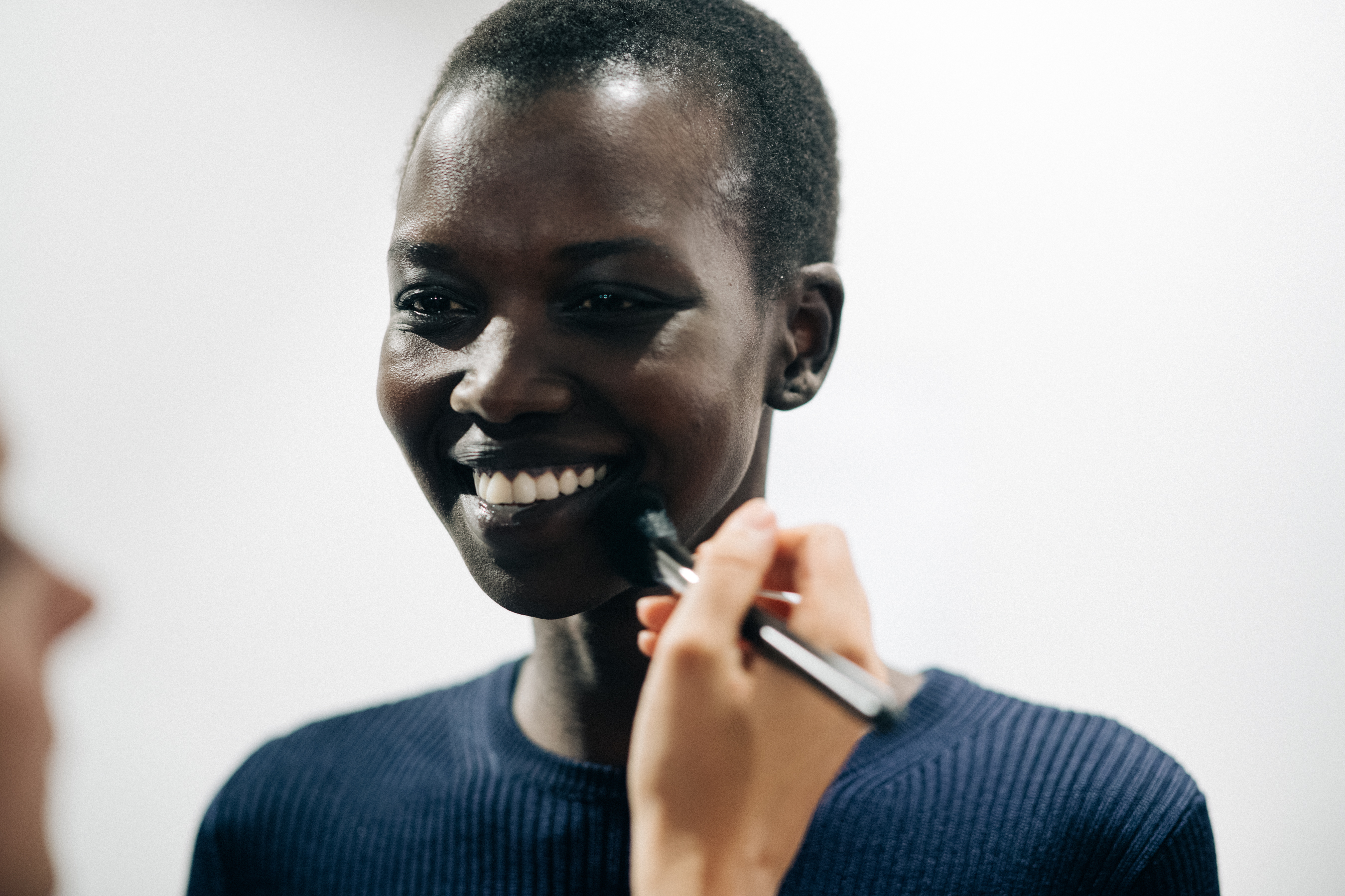 Model getting make up done before a show