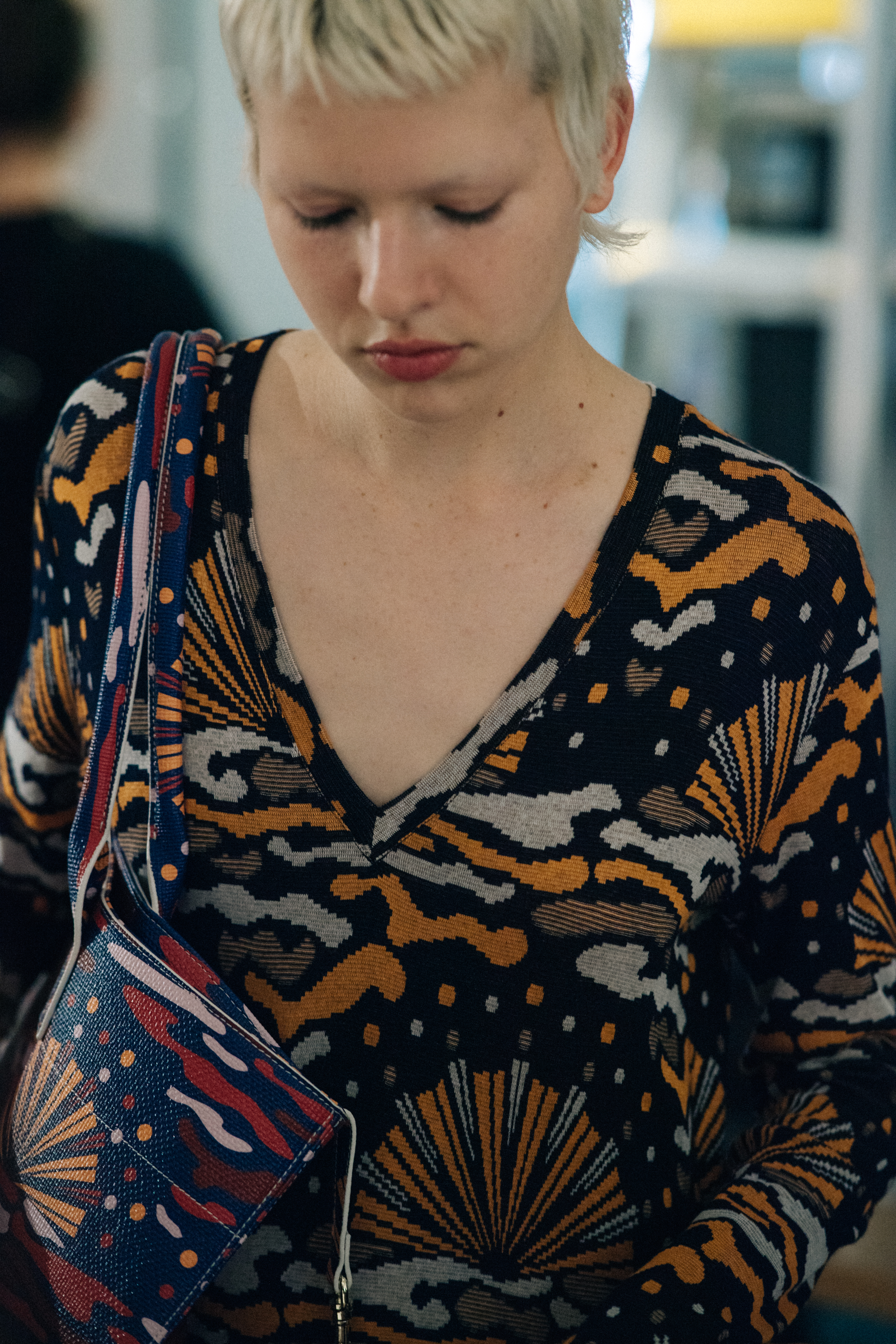 Model wearing printed dress and bag