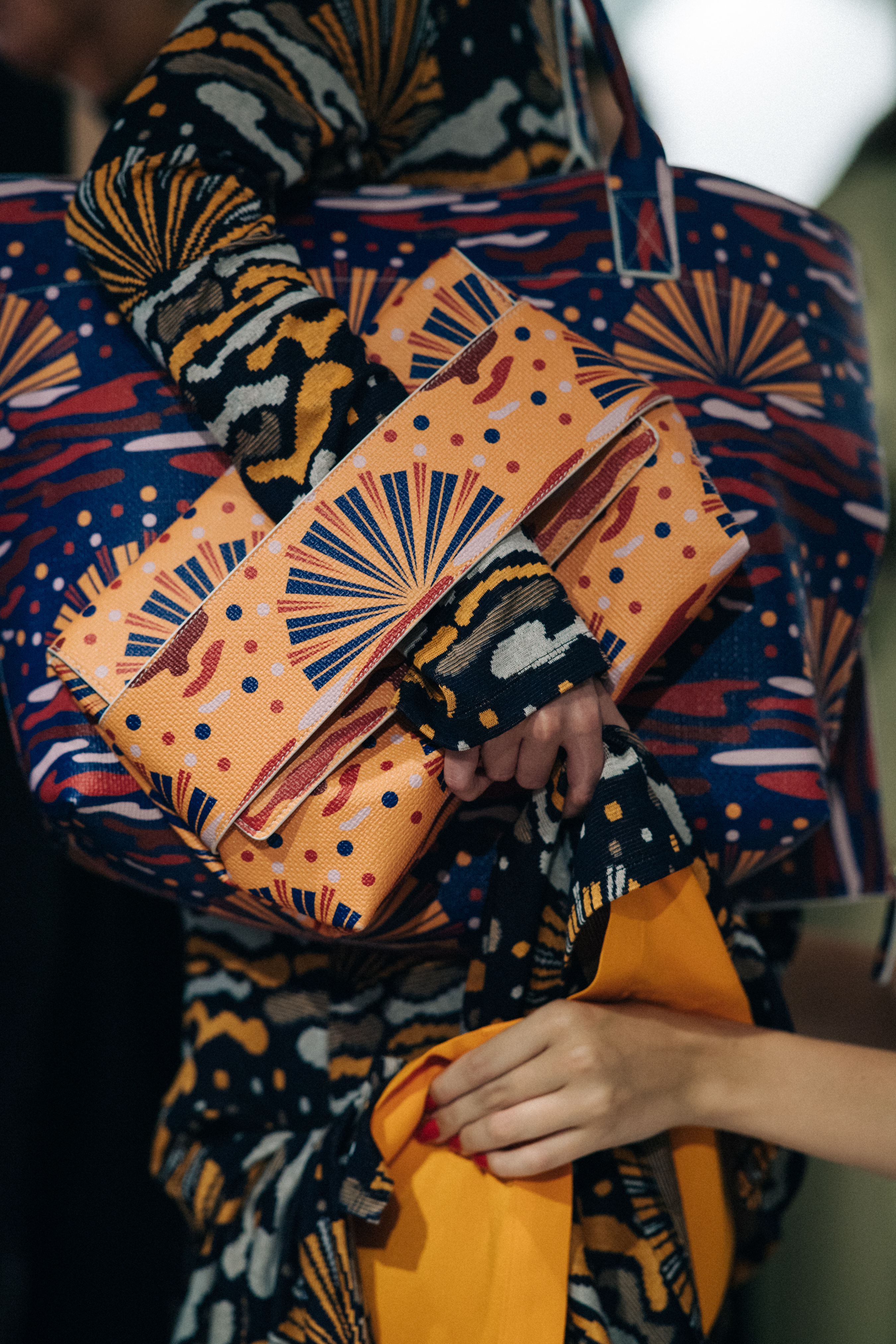 Model wearing printed dress and bag