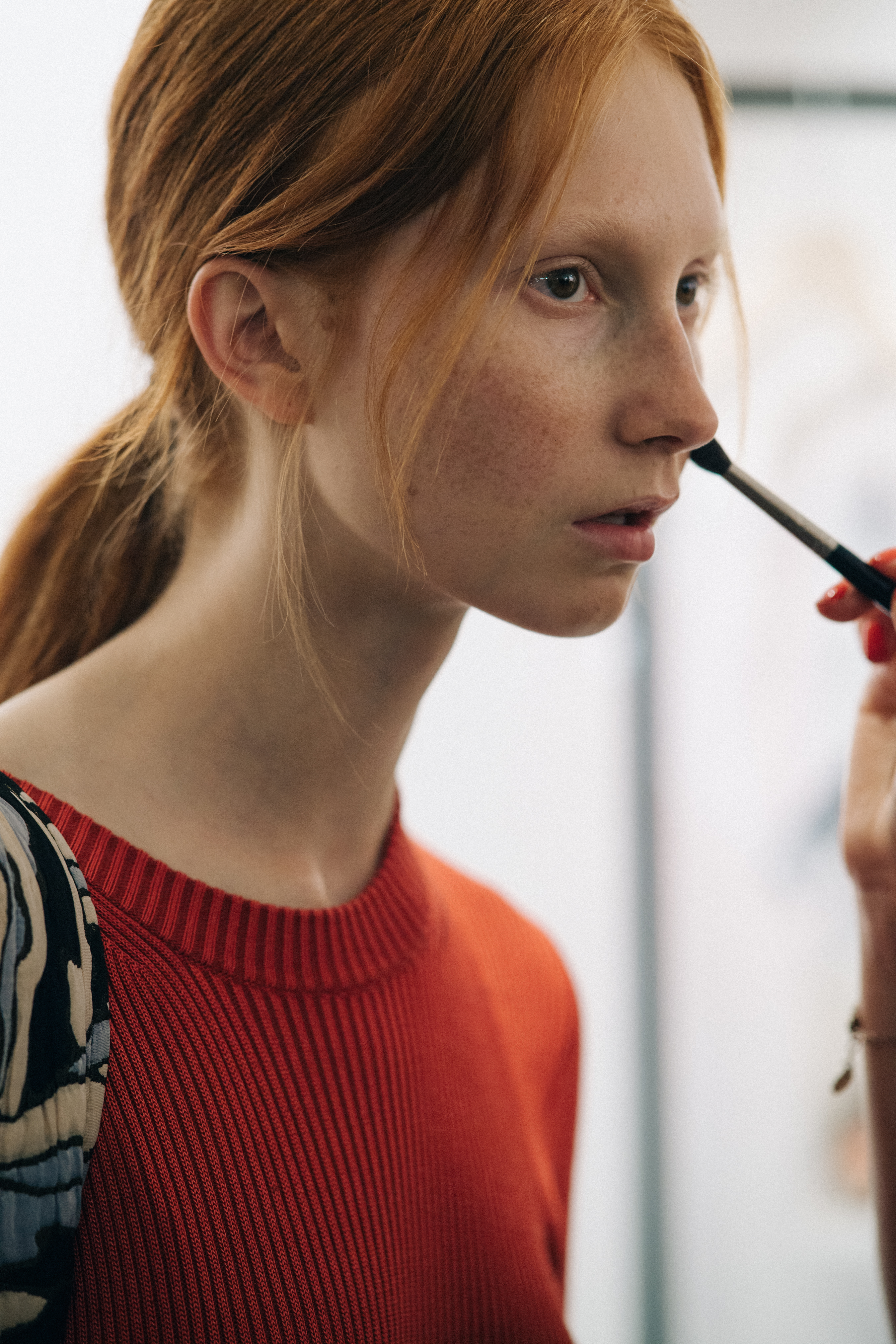 Model wearing red sweater