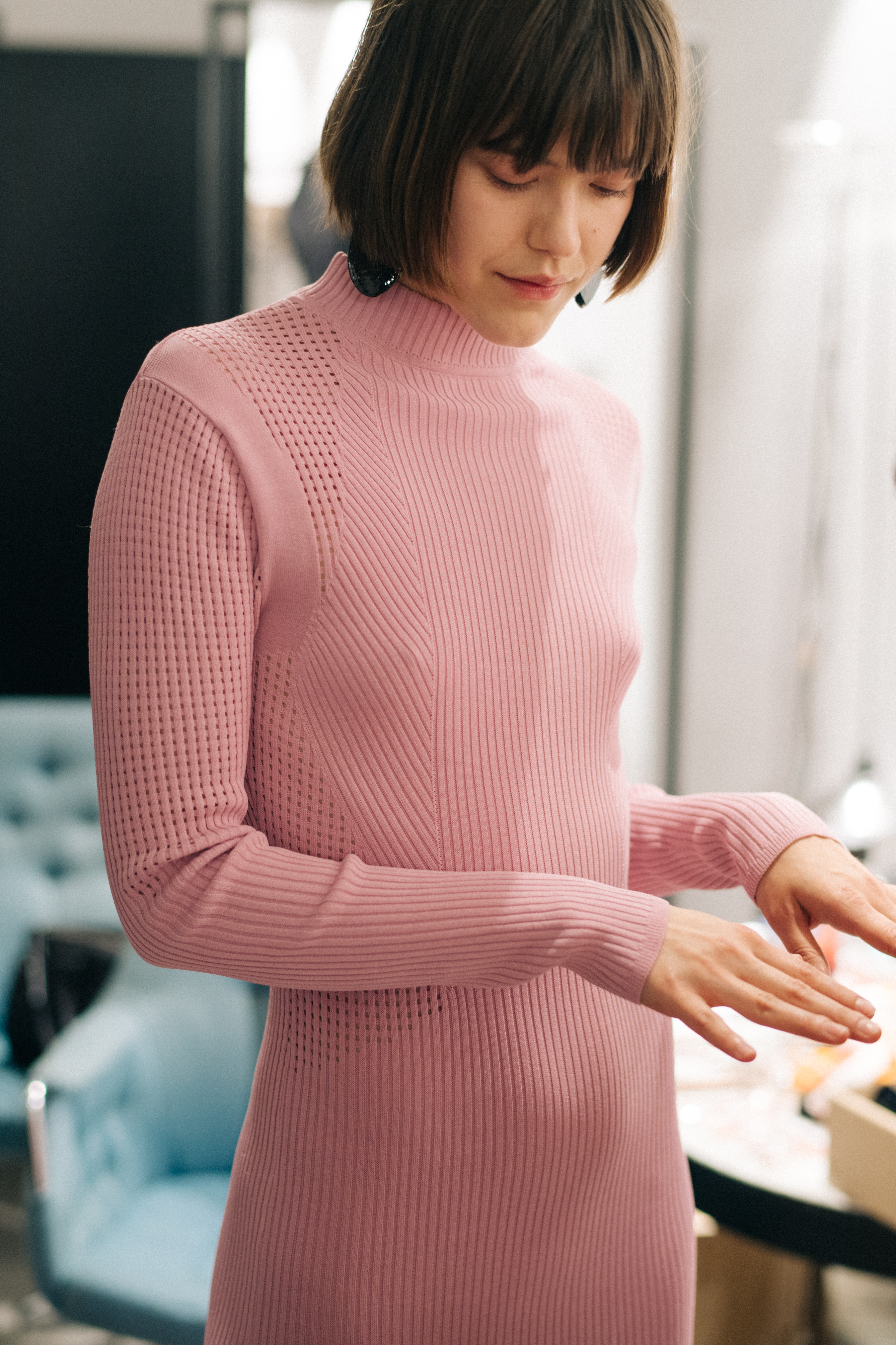 Model wearing pink sweater dress