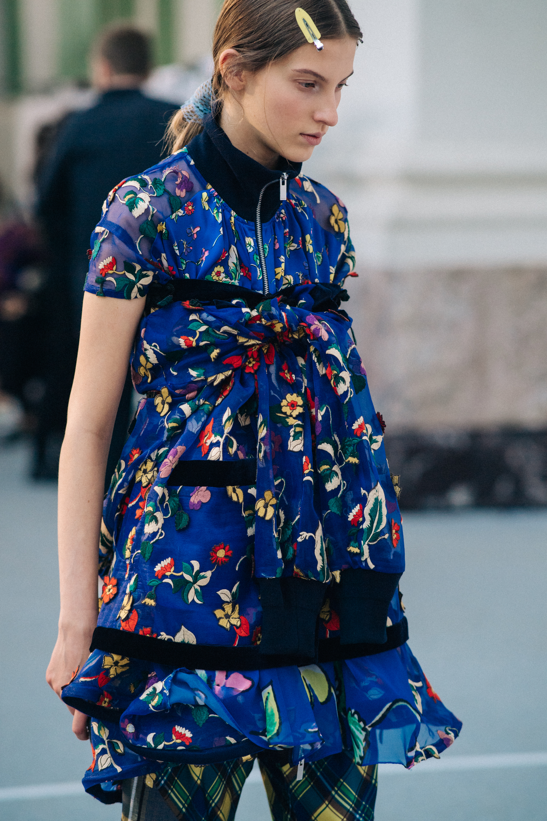 Model wearing floral dress before a show