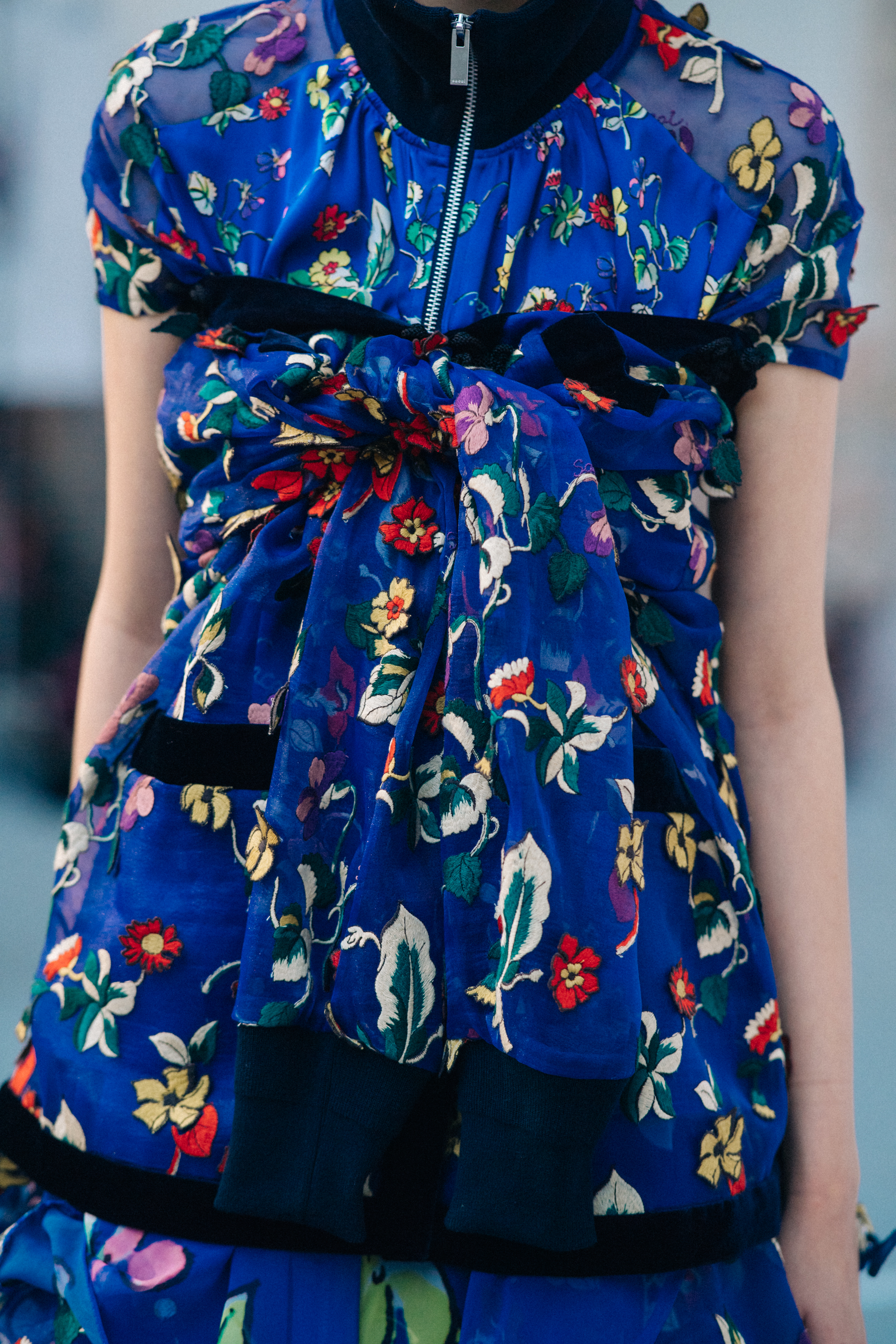 Model wearing floral dress before a show