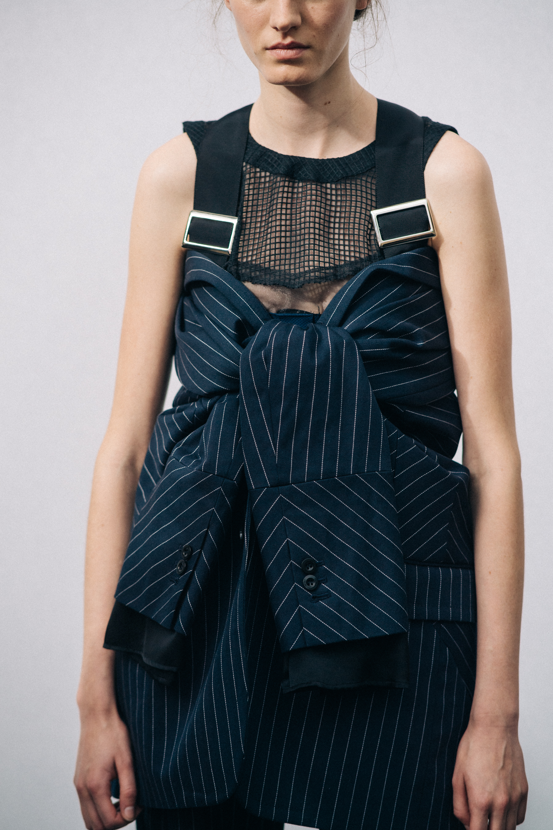 Model wearing black outfit before a show