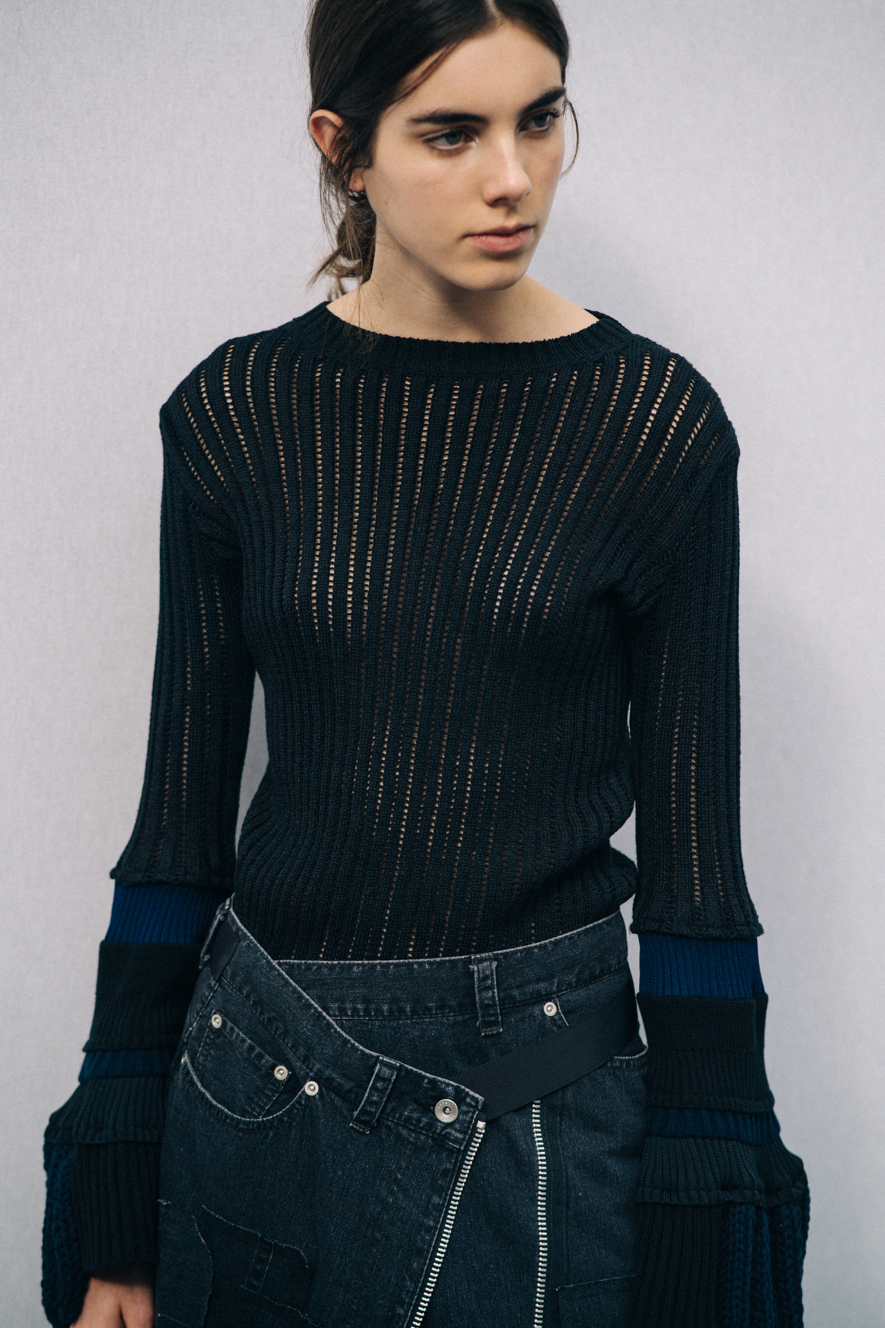 Model wearing black outfit before a show