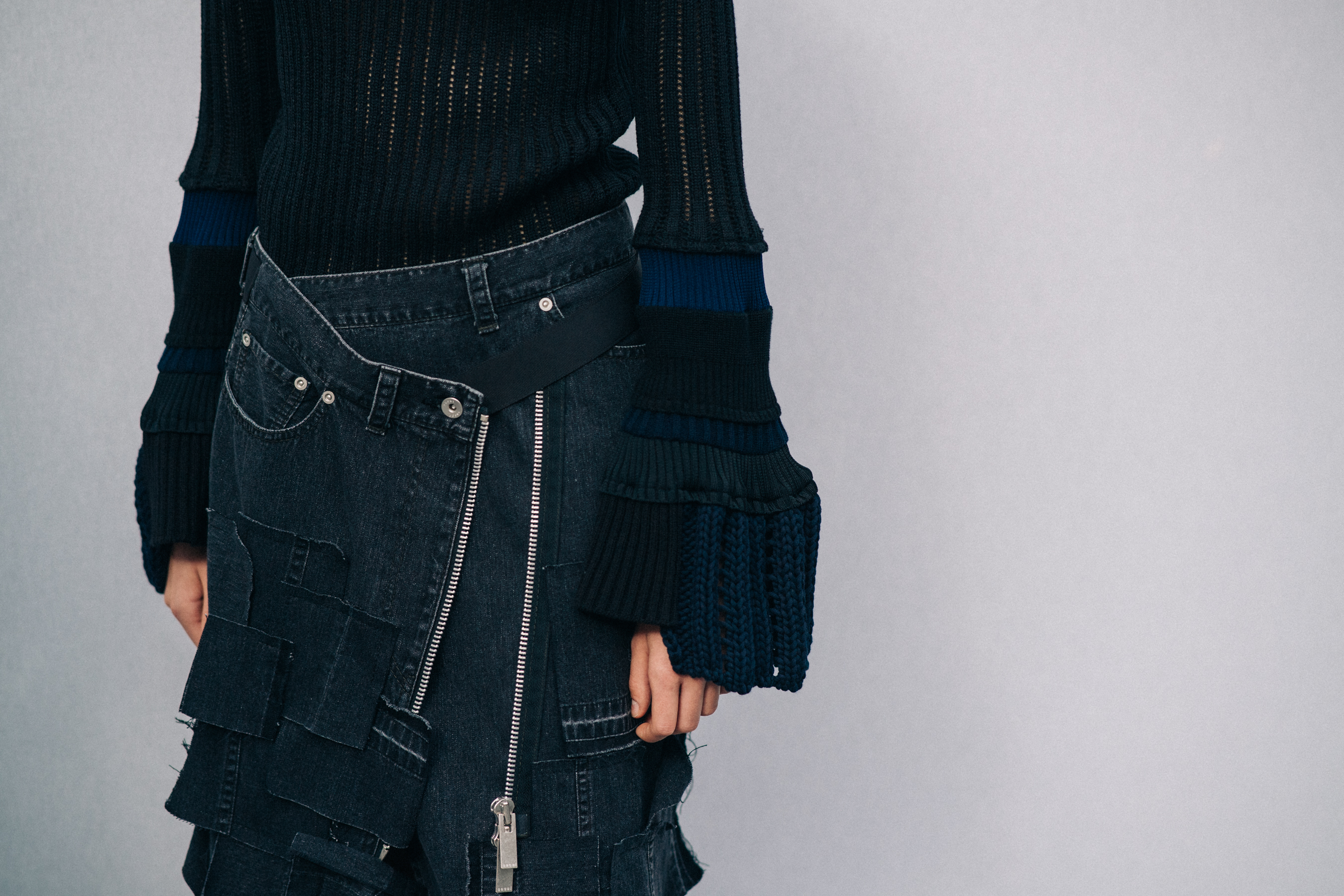 Model wearing black outfit before a show
