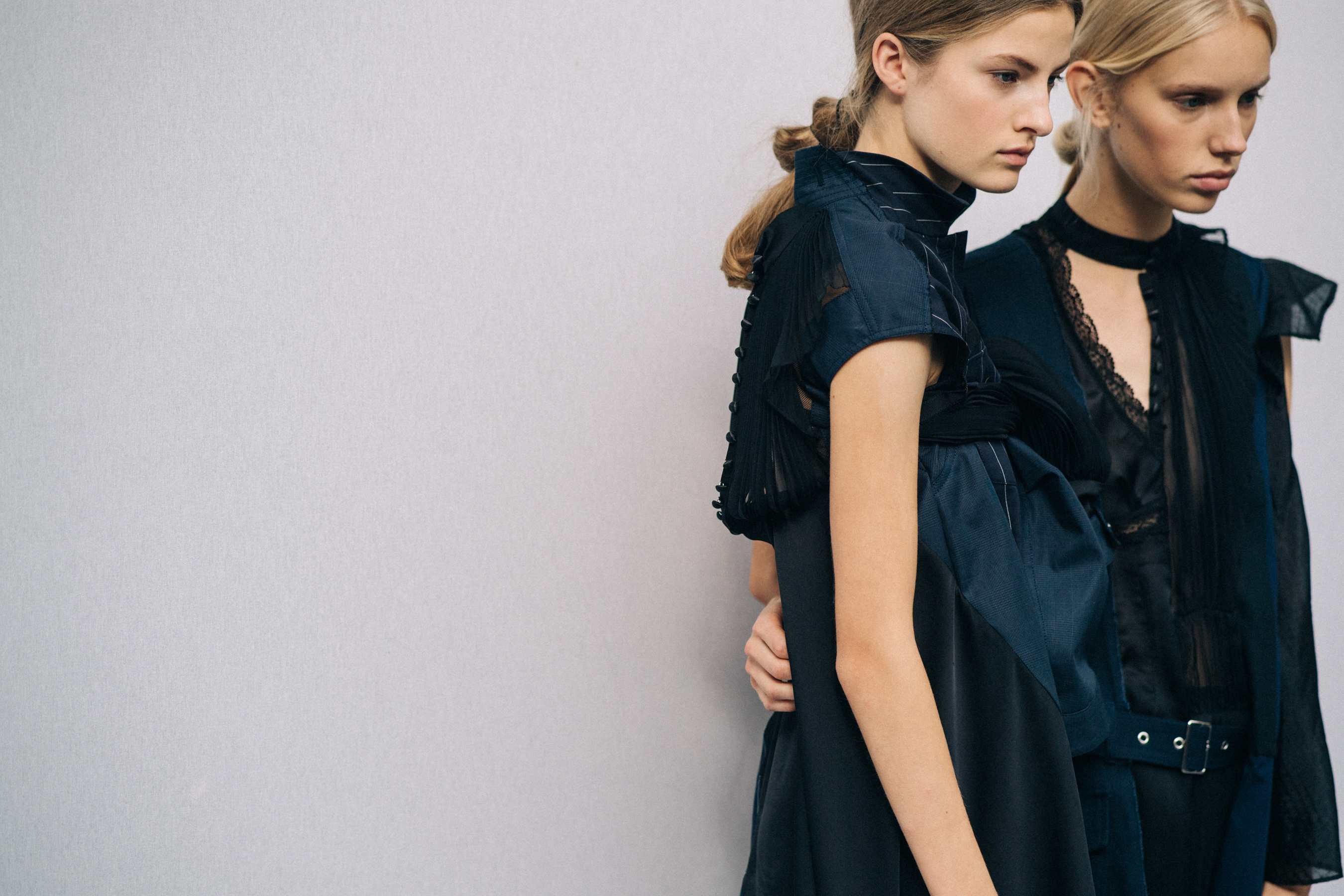Model wearing black outfit before a show