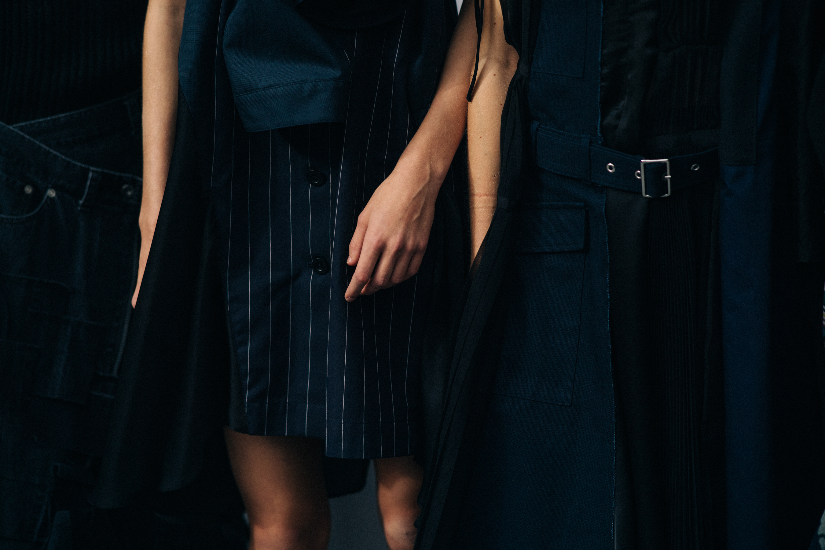 Model wearing black outfit before a show