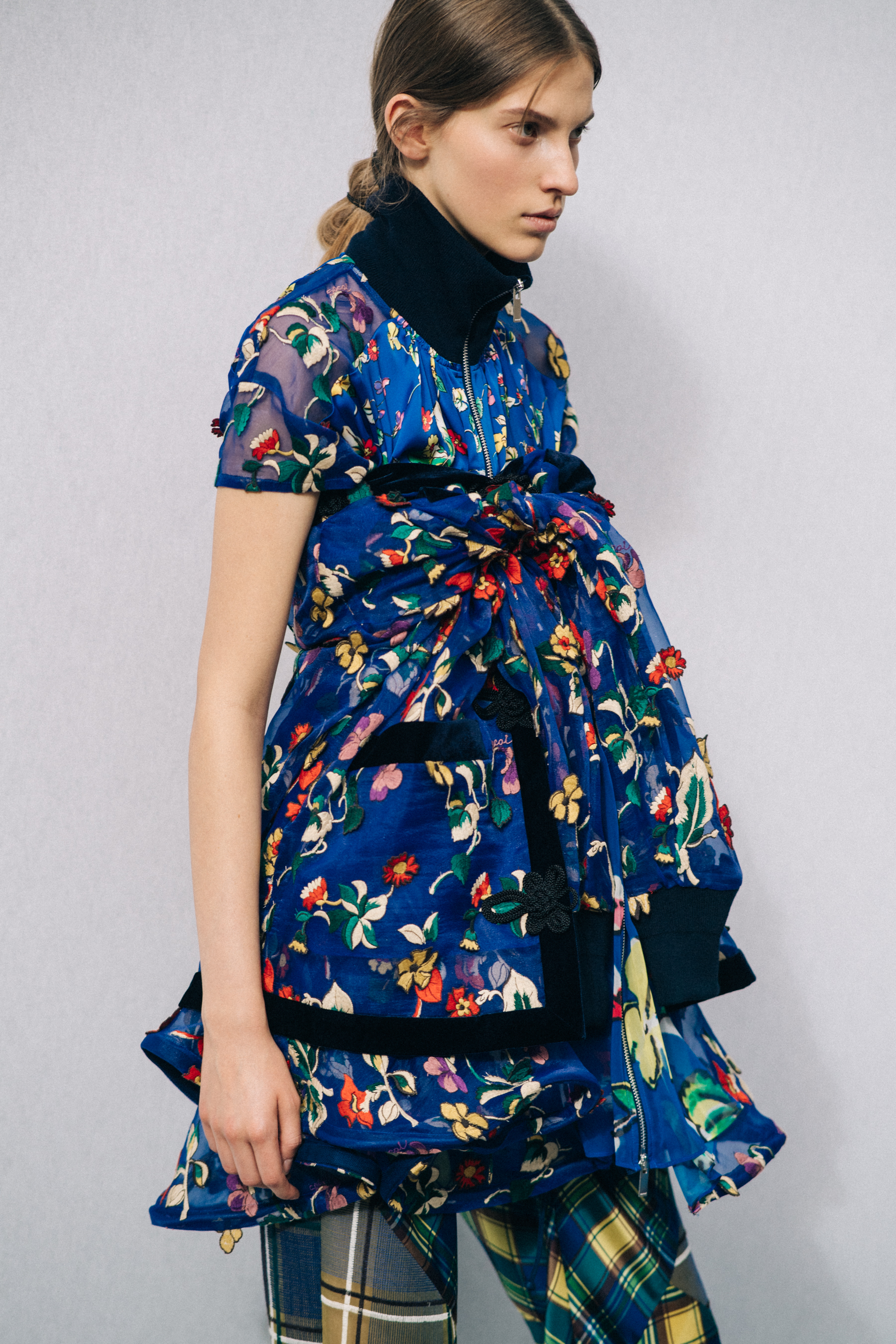 Model wearing floral dress before a show