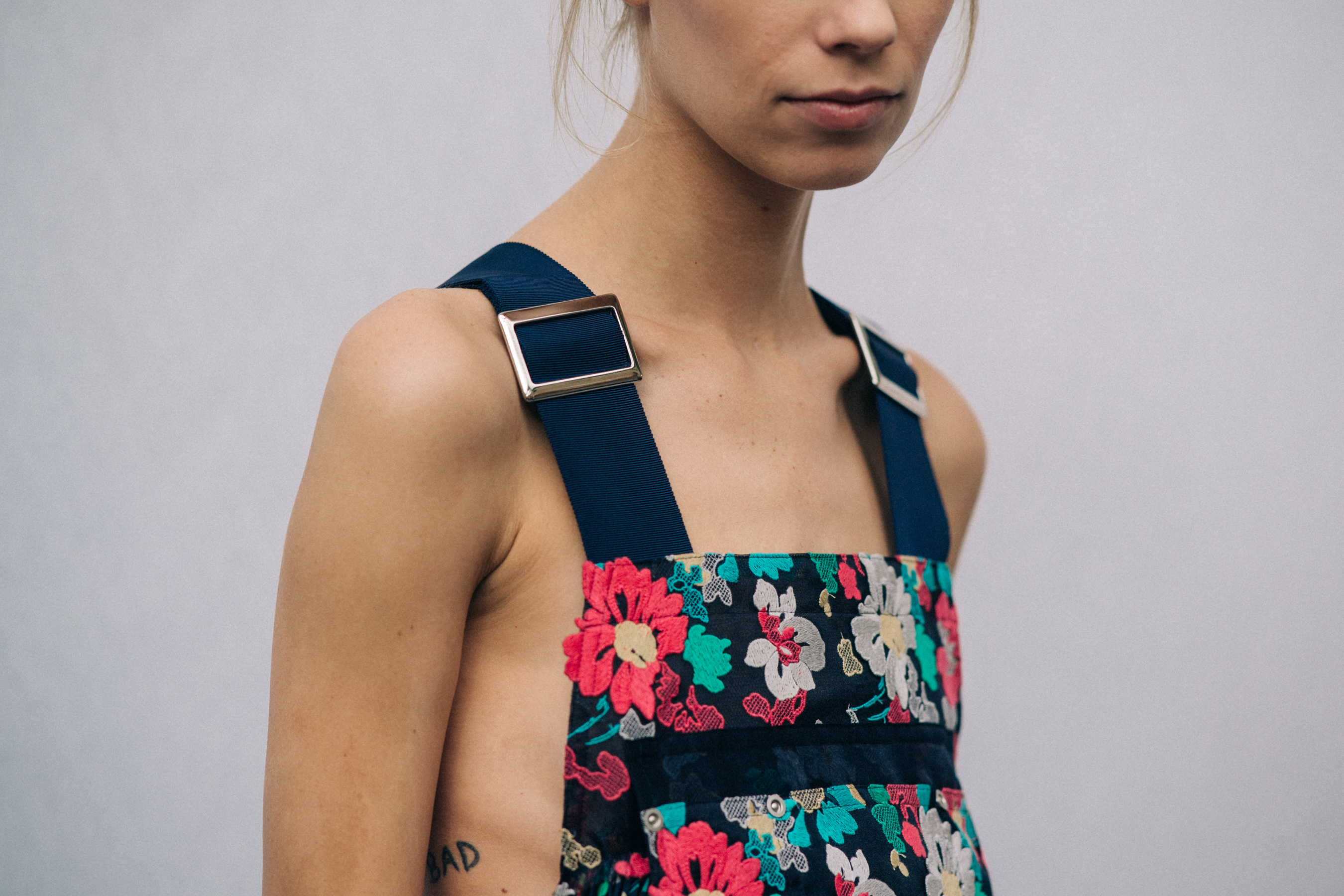 Model wearing floral dress before a show