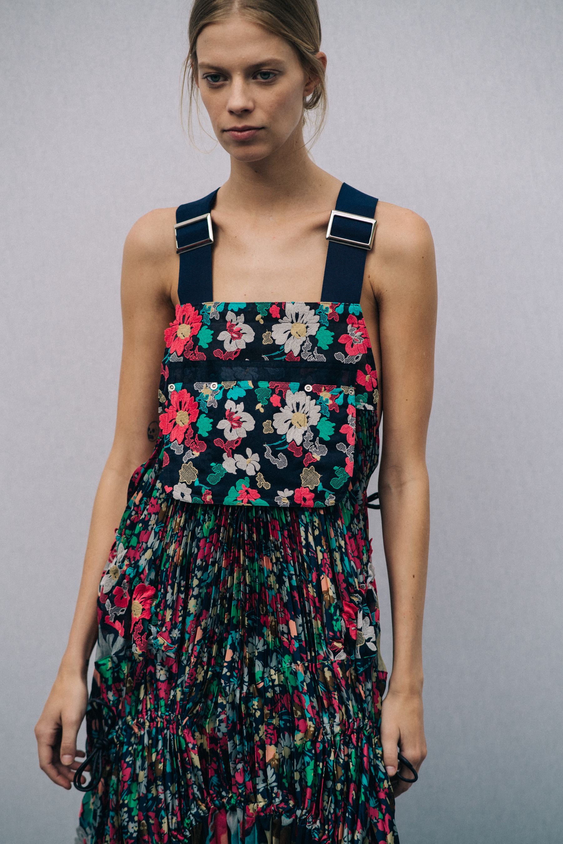 Model wearing floral dress before a show