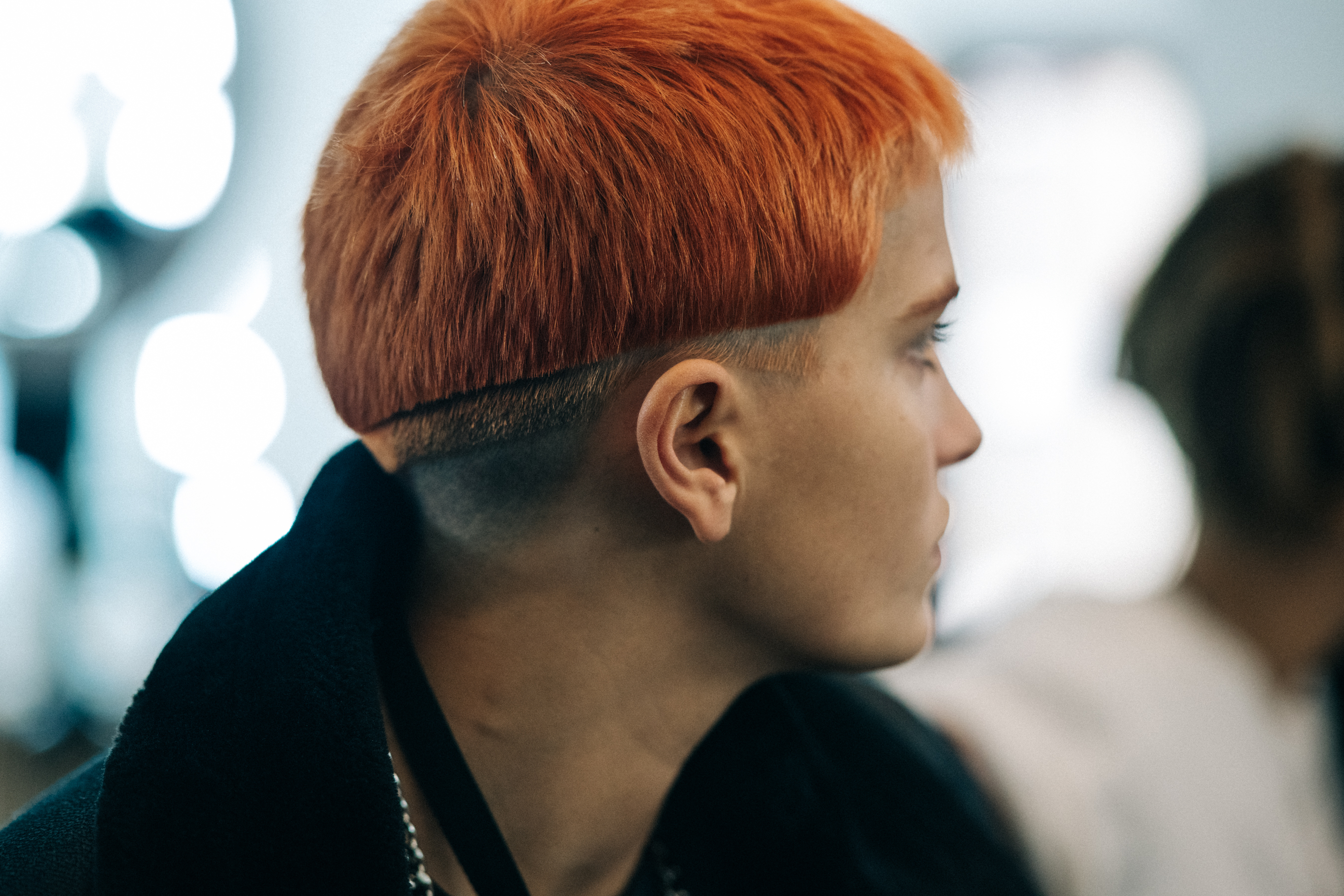 Model backstage with orange hair