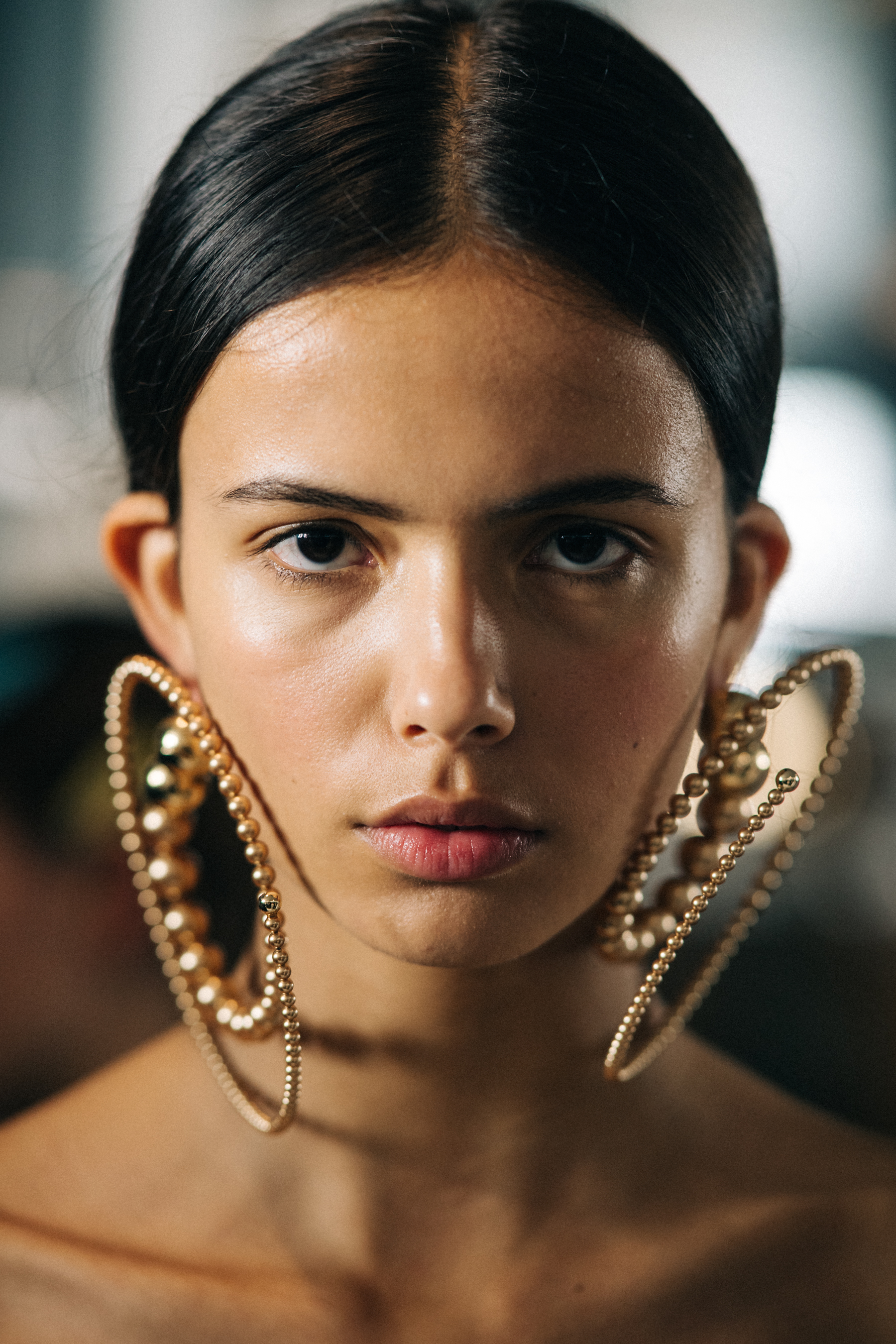 Model wearing spiral earrings