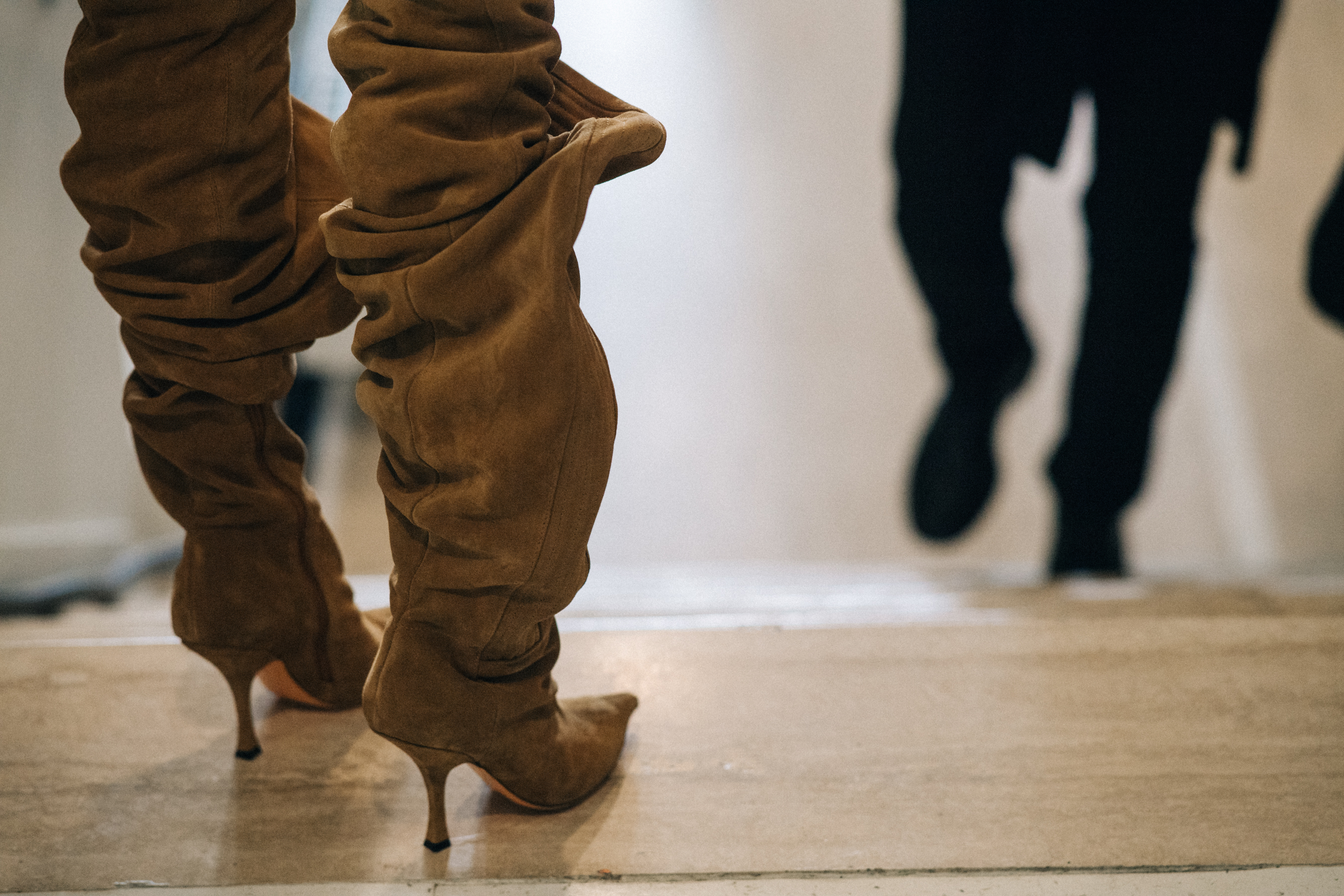 Model wearing high heeled boots