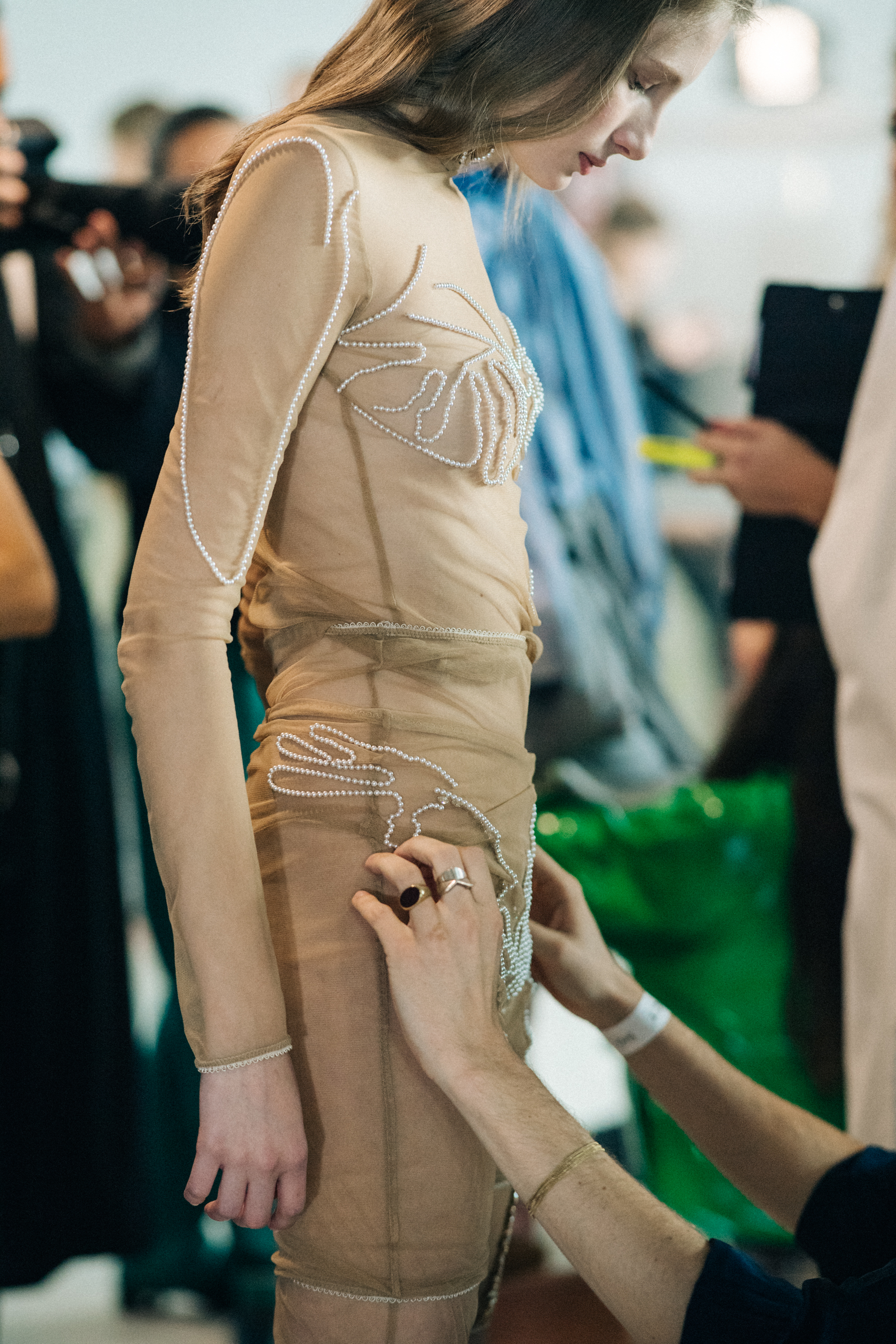 Model wearing transparent beaded jumpsuit