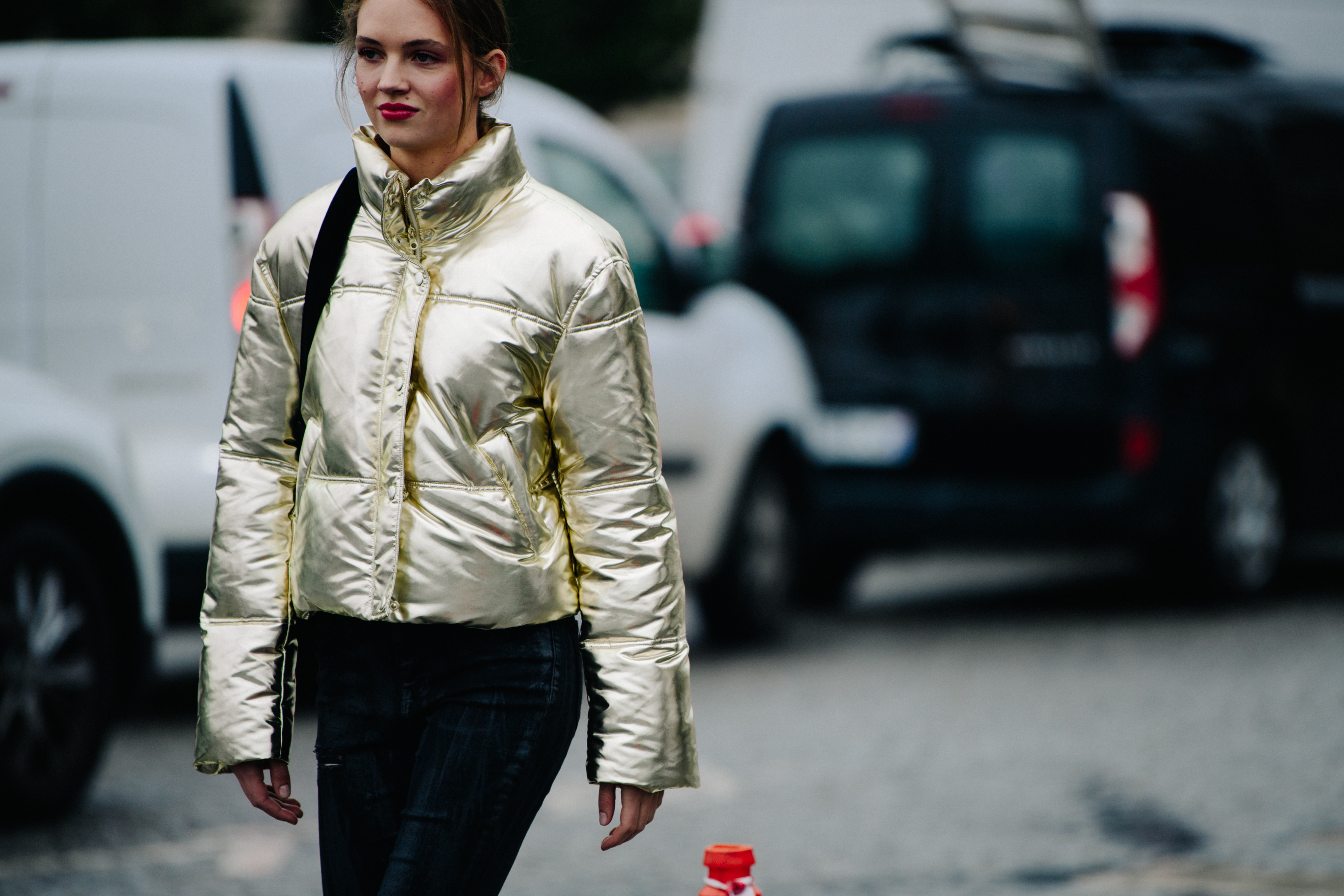 Model wearing gold jacket after Chanel